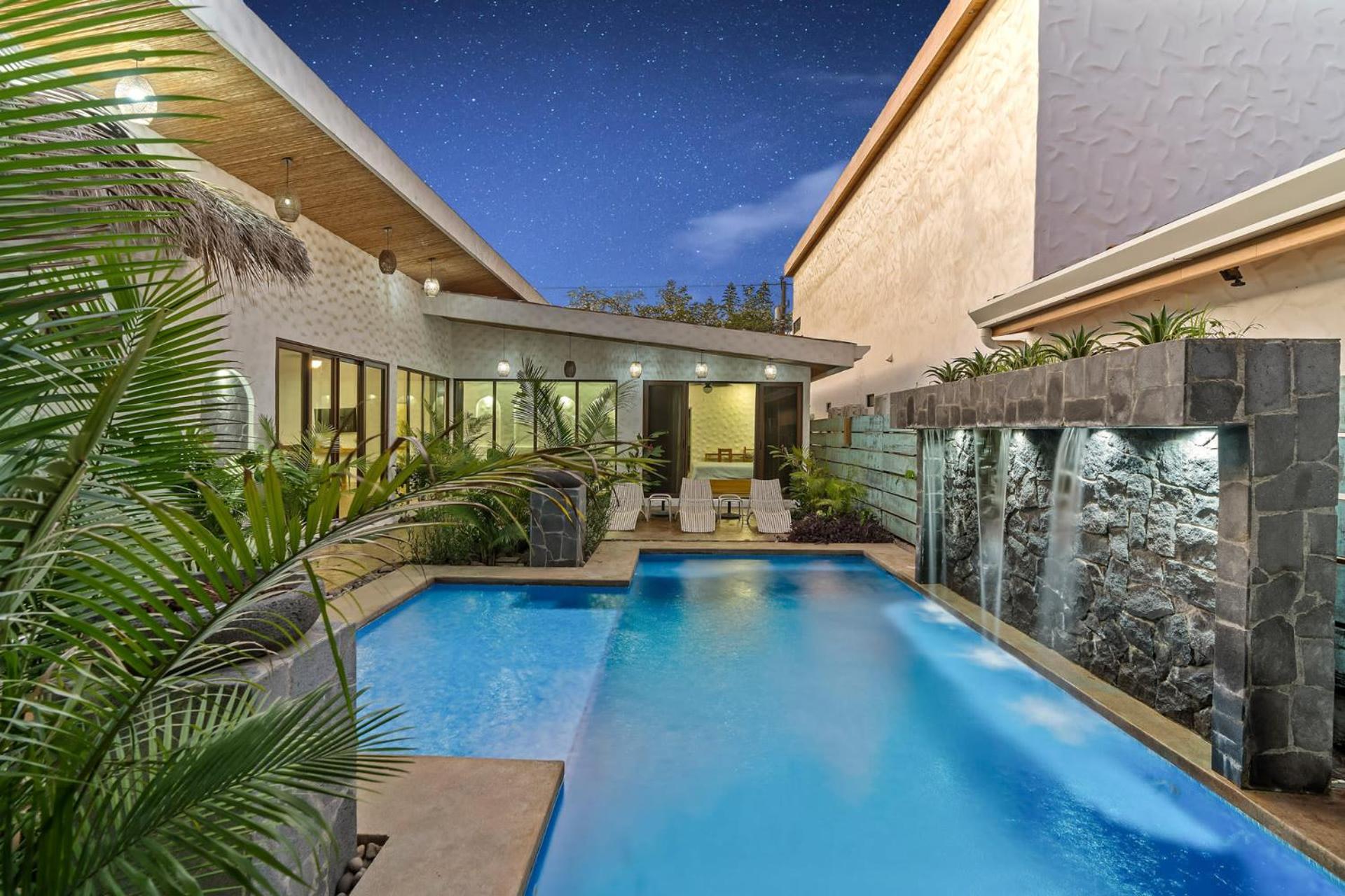 Modern Home with Chic Bohemian Style and Zen Outdoor Oasis with Swimming Pool and Tiki Style Dining Space