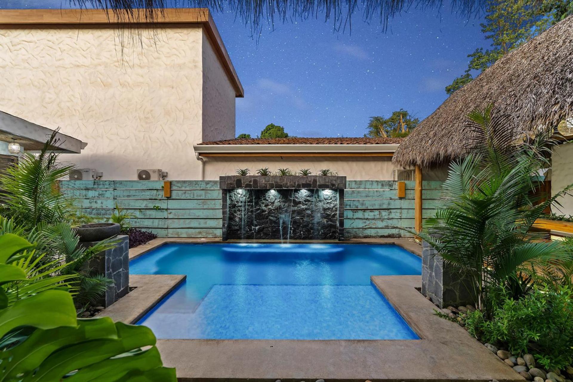 Modern Home with Chic Bohemian Style and Zen Outdoor Oasis with Swimming Pool and Tiki Style Dining Space
