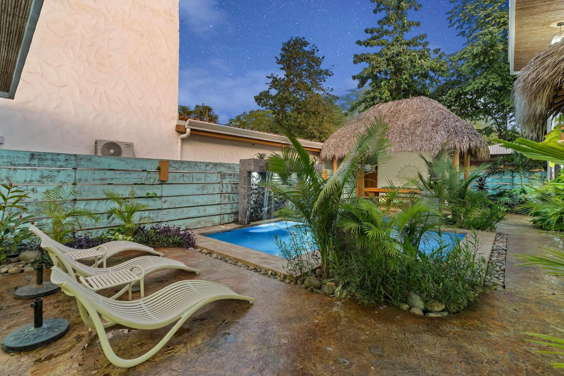 Modern Home with Chic Bohemian Style and Zen Outdoor Oasis with Swimming Pool and Tiki Style Dining Space