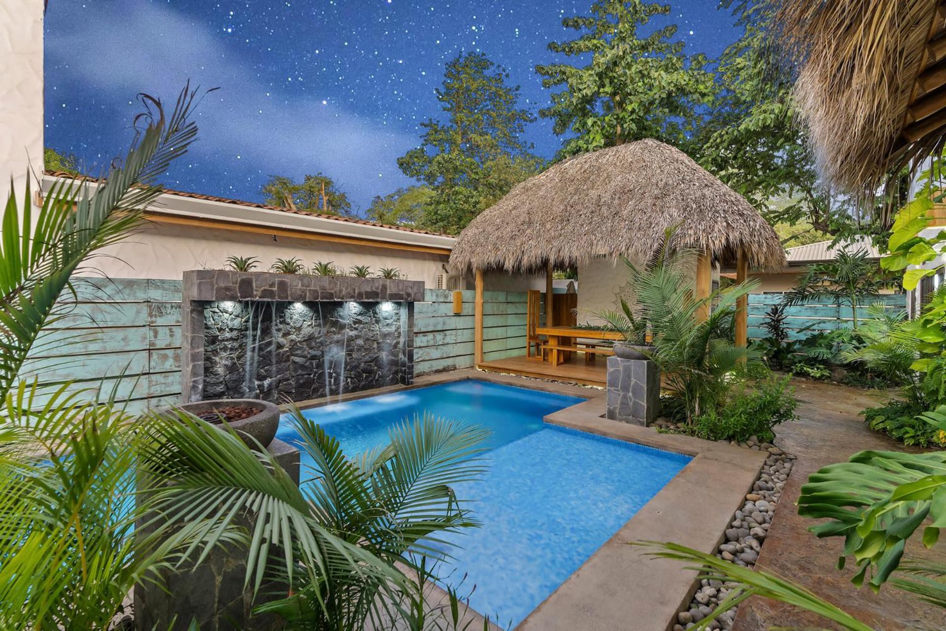 Modern Home with Chic Bohemian Style and Zen Outdoor Oasis with Swimming Pool and Tiki Style Dining Space