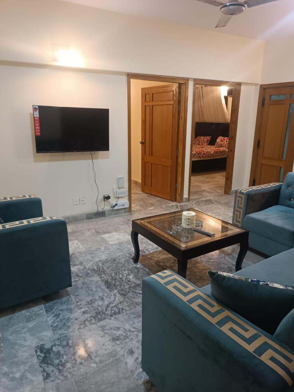F-10 two bed Posh Apartment lounge kitchen AC WiFi smart Tv view 5
