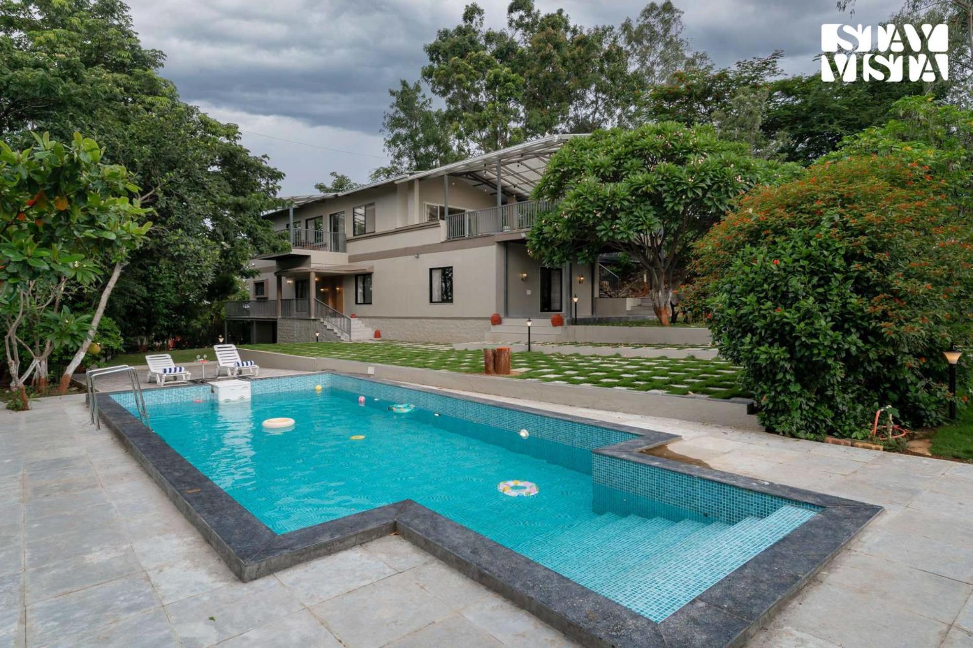 StayVista at Amber & Mist - Pool and Lawn view 4