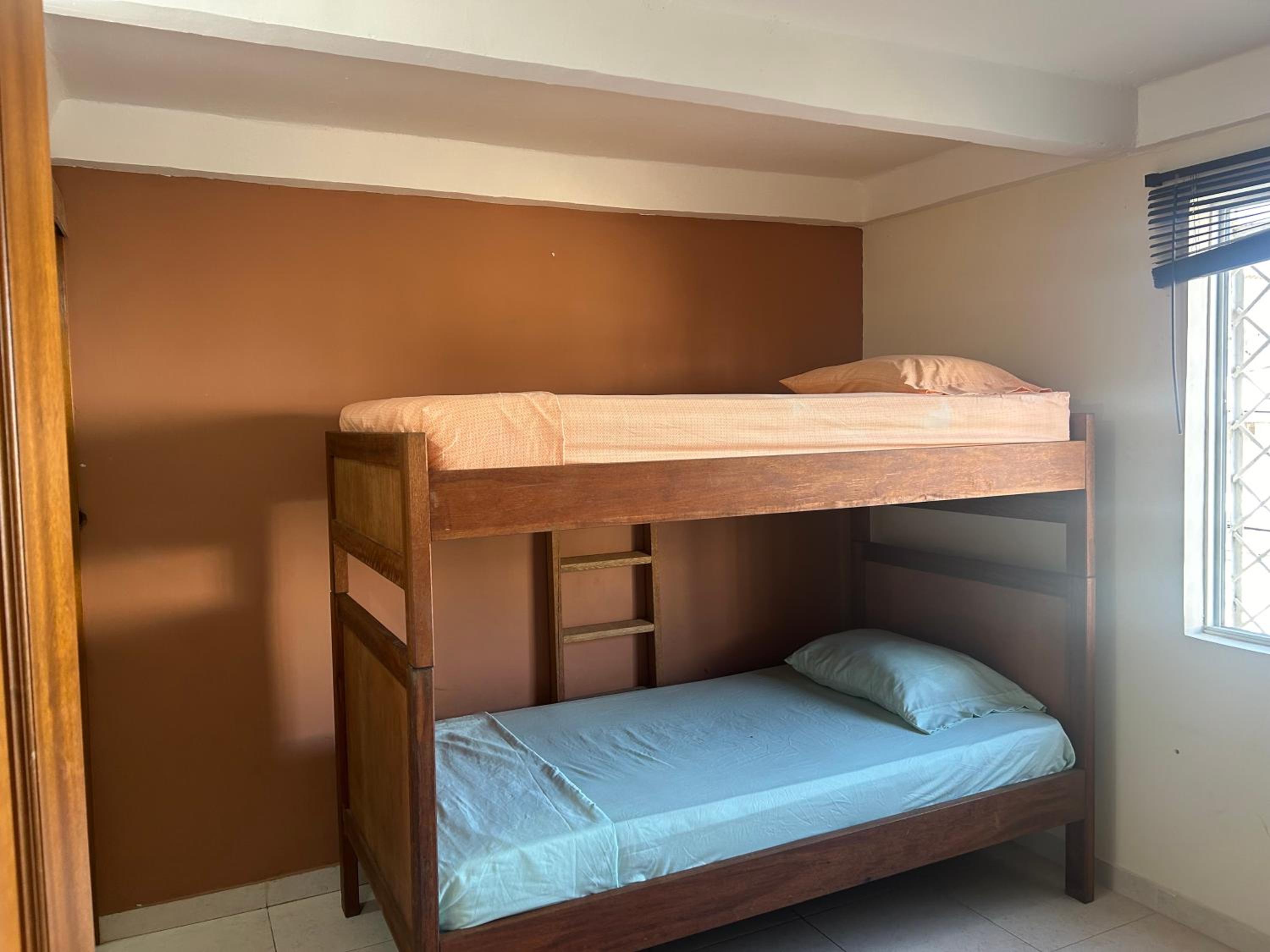 La Suite Caribeña Room with a bunk bed and private bathroom with a fan