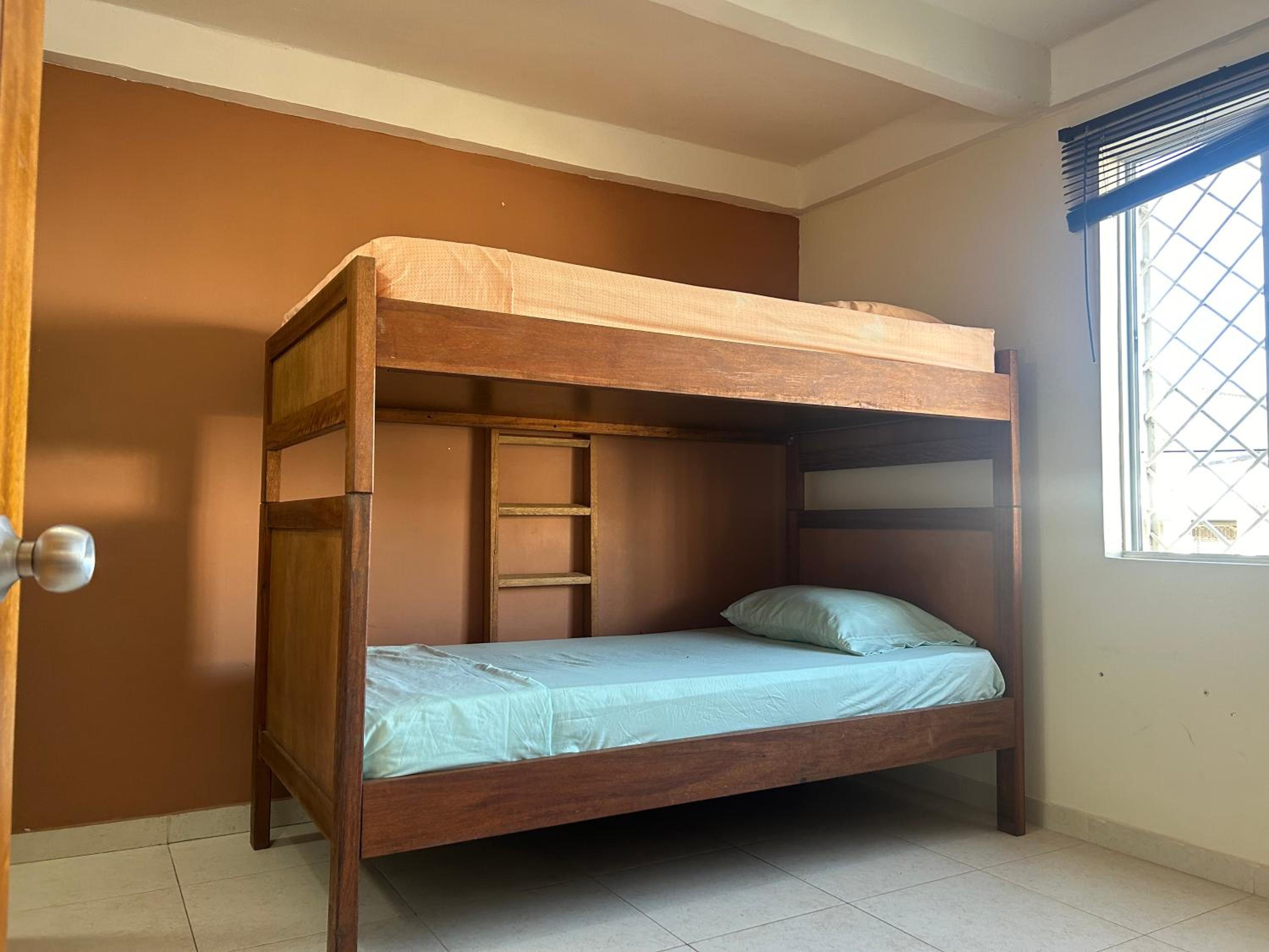 La Suite Caribeña Room with a bunk bed and private bathroom with a fan