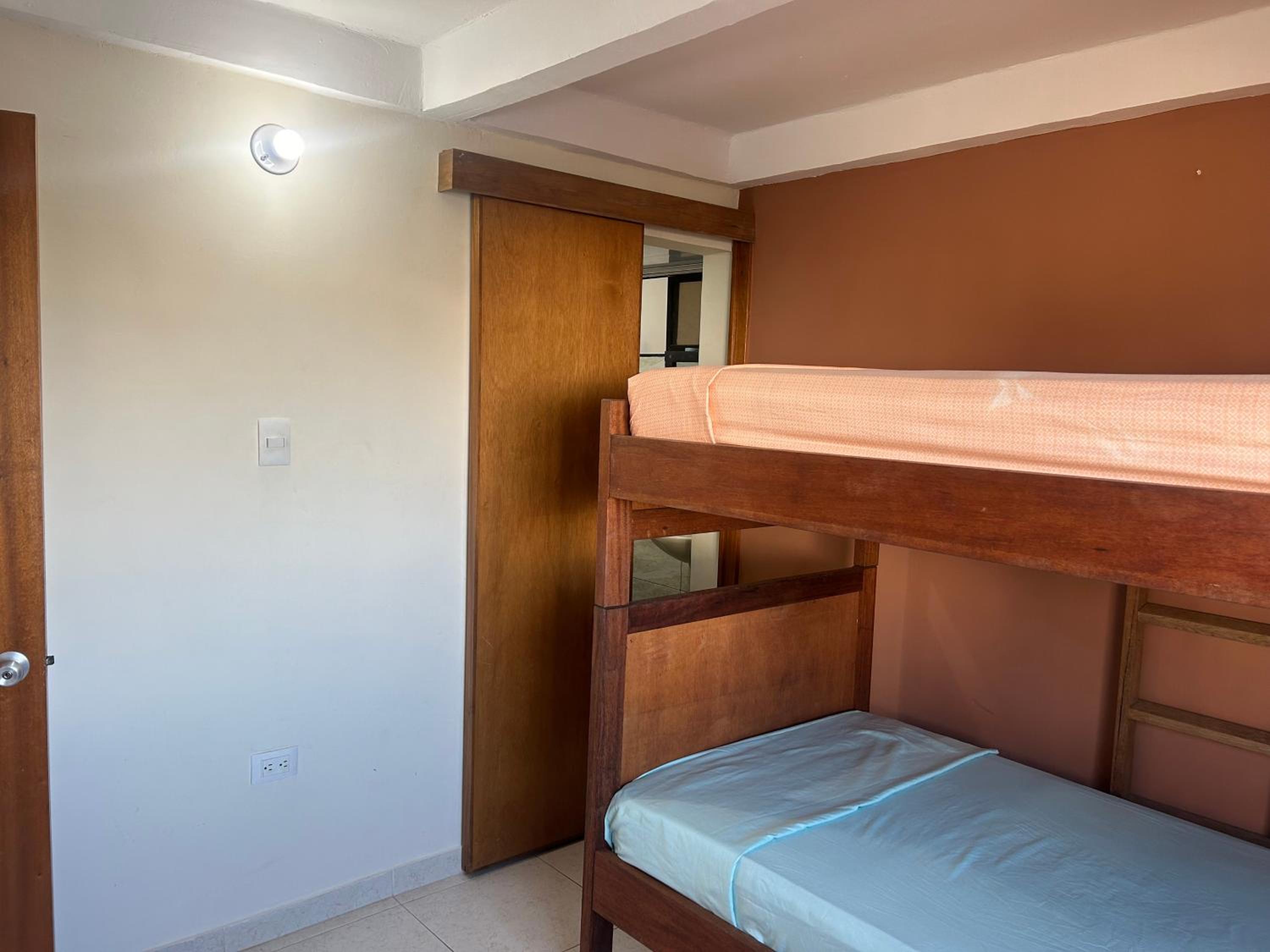 La Suite Caribeña Room with a bunk bed and private bathroom with a fan