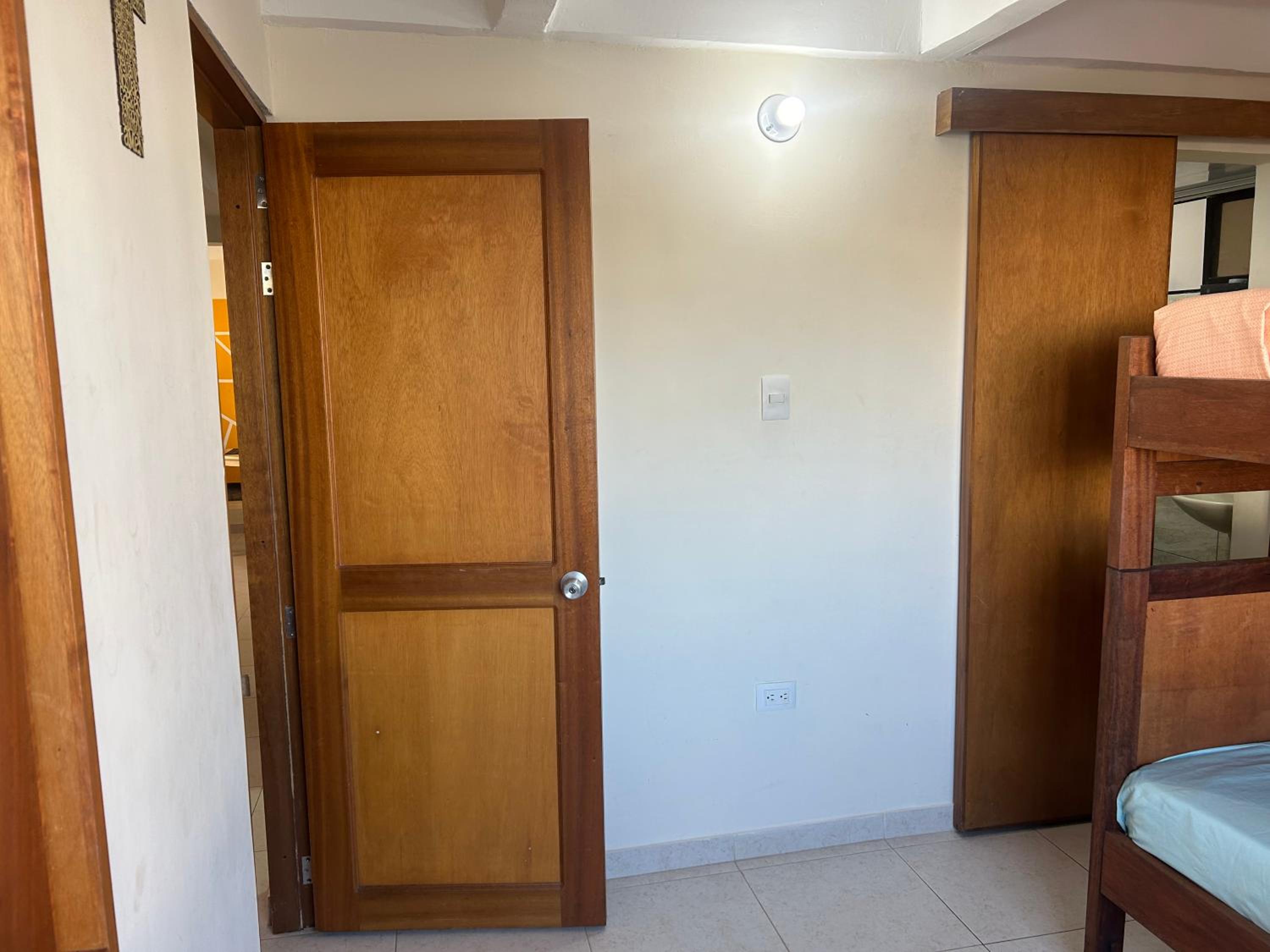 La Suite Caribeña Room with a bunk bed and private bathroom with a fan
