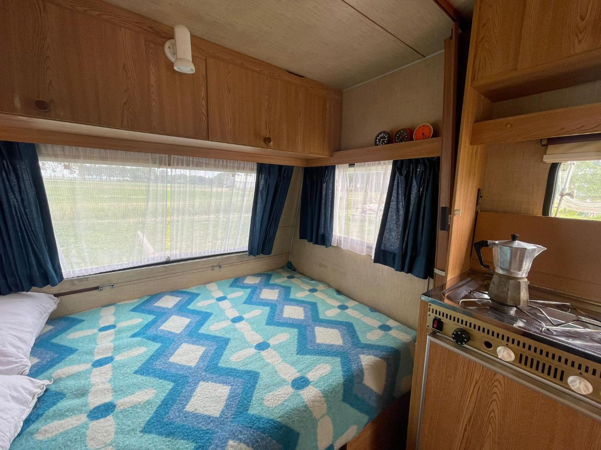 Vintage caravan in old orchard at farm Huize Blokland