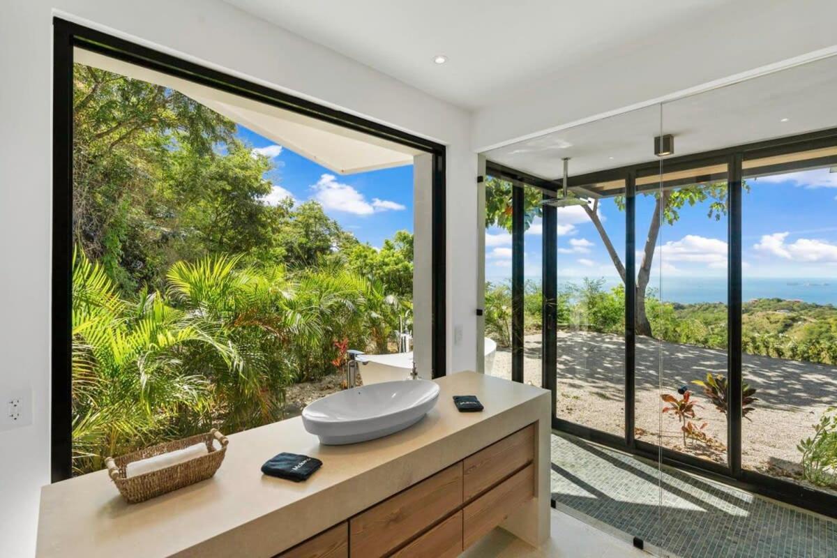 Luxurious Ultramodern Property with Private Suites, Infinity Pool, and Sweeping Ocean and Mountain Views