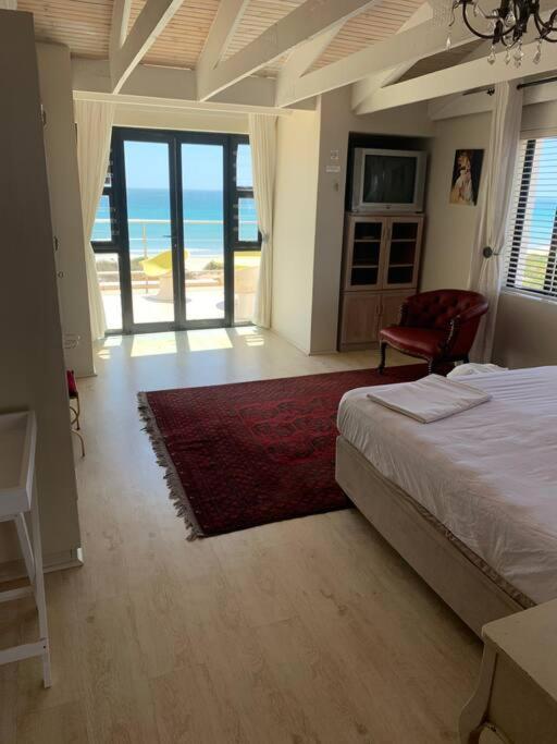 BEACH FRONT BEAUTY 50 meters from beach sand view 3