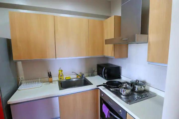 5-mins SM AURA COZY 2BR Free Parking view 2