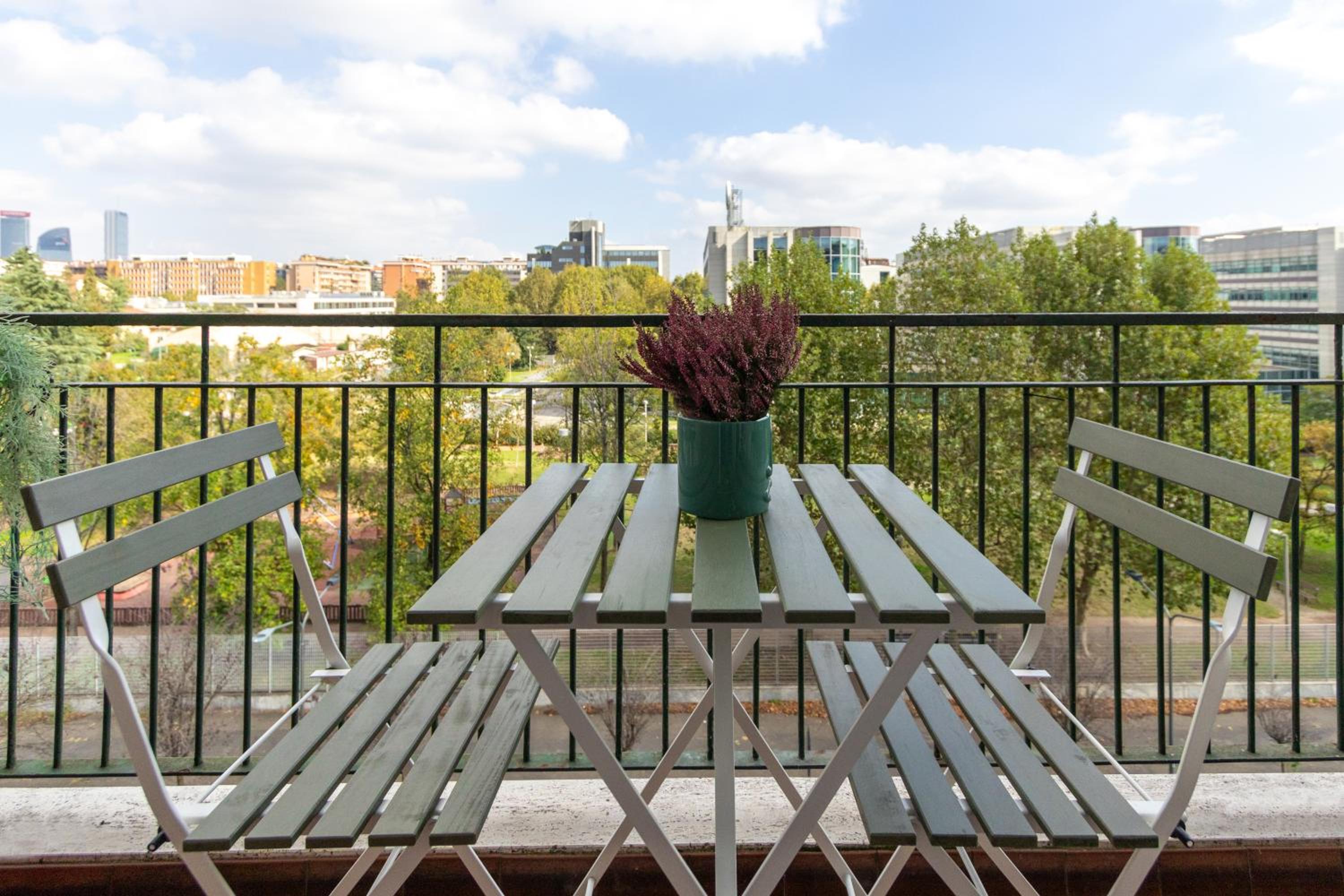 Modern suite with balcony and park view