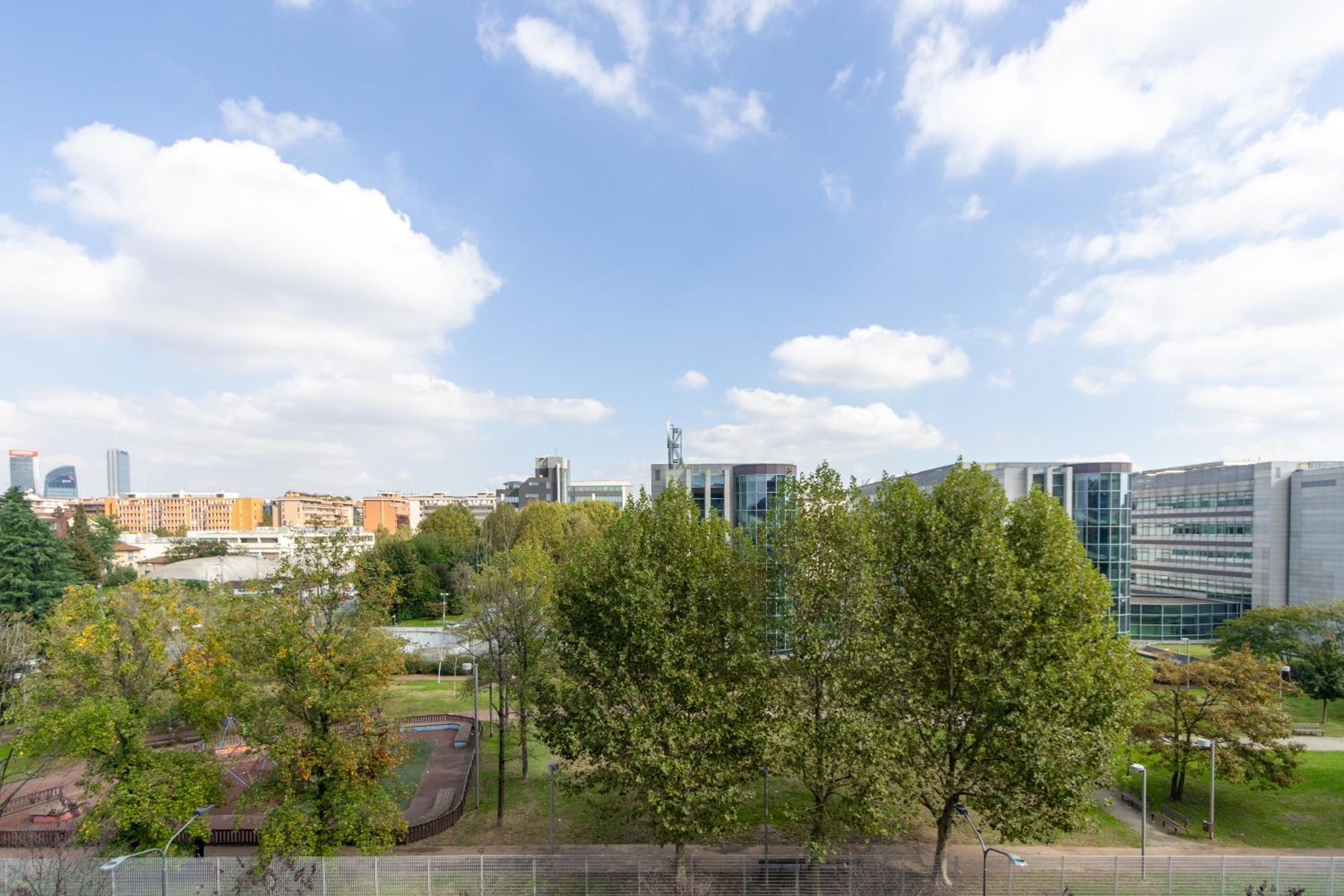 Modern suite with balcony and park view