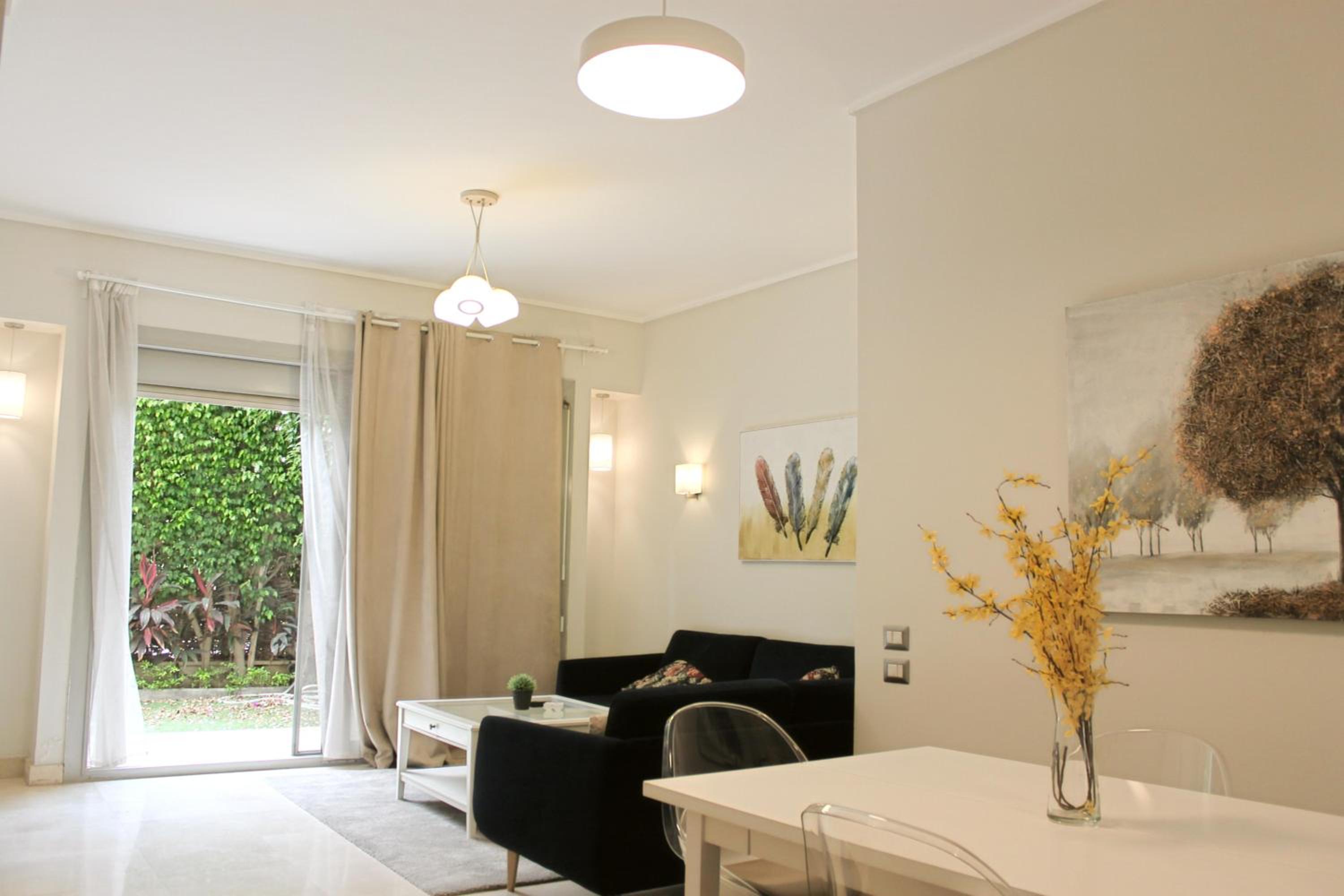 Private Garden 1BR Apt in Palm Hills AUC New Cairo