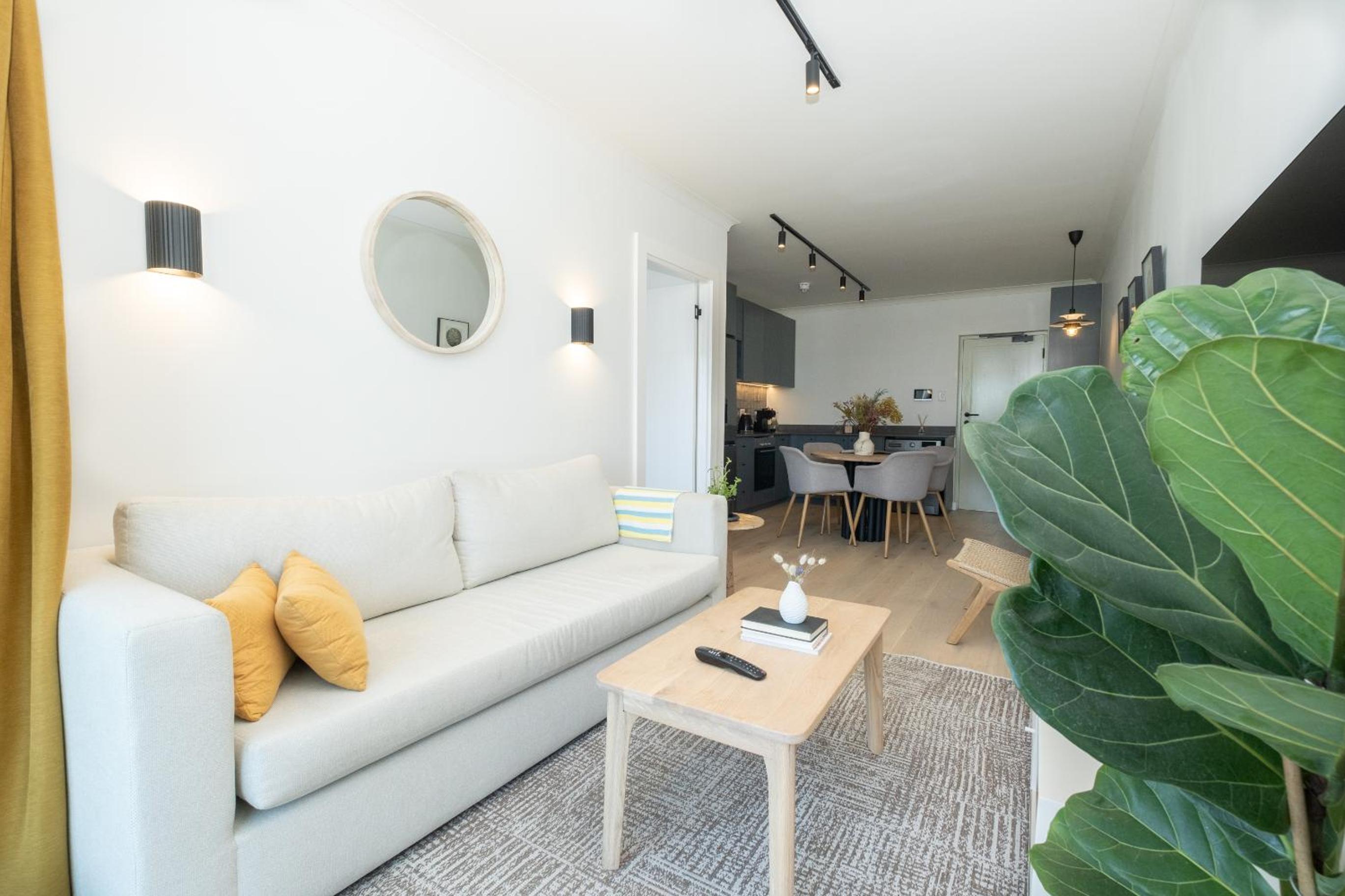 Stylish 1-Full Bedroom Apartment with a separate Living Room, Workspace and Kitchen close to the beach and best restaurants in Cape Town, secure parking view 2