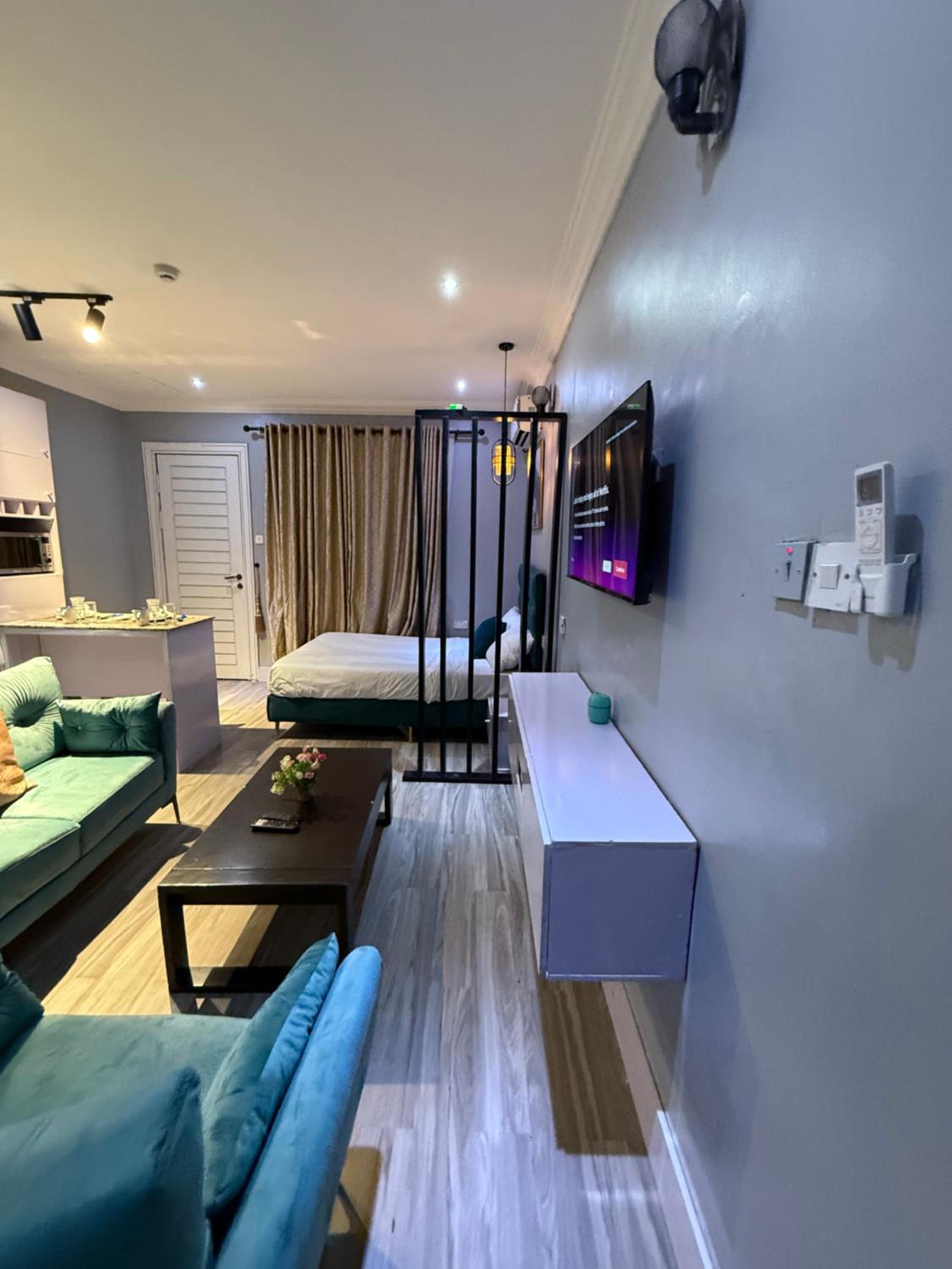 Balcony Teal Snug Open-Plan Studio Unit in Lekki Phase 1-Netflix, Wi-Fi, 24-7 Light, Washer, Kitchen view 4