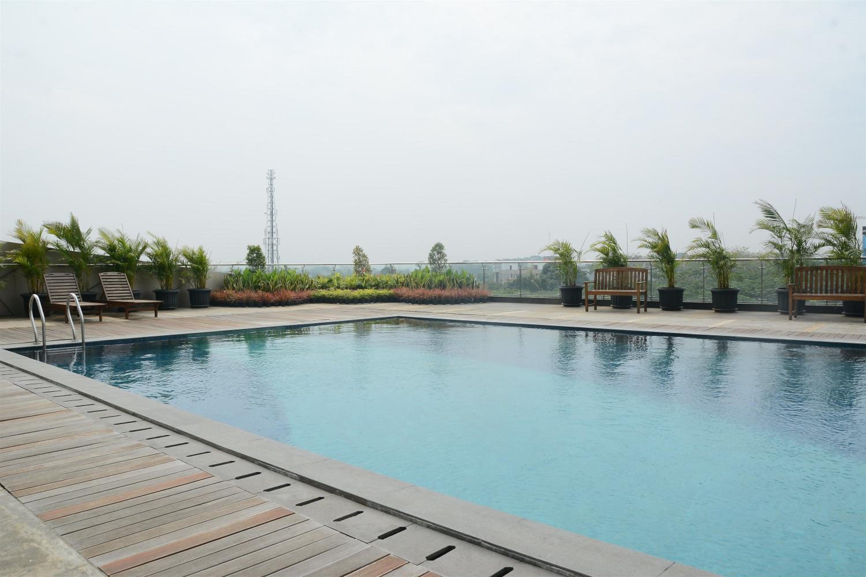Homey and Cozy Studio Room at Tree Park City BSD Apartment By Travelio