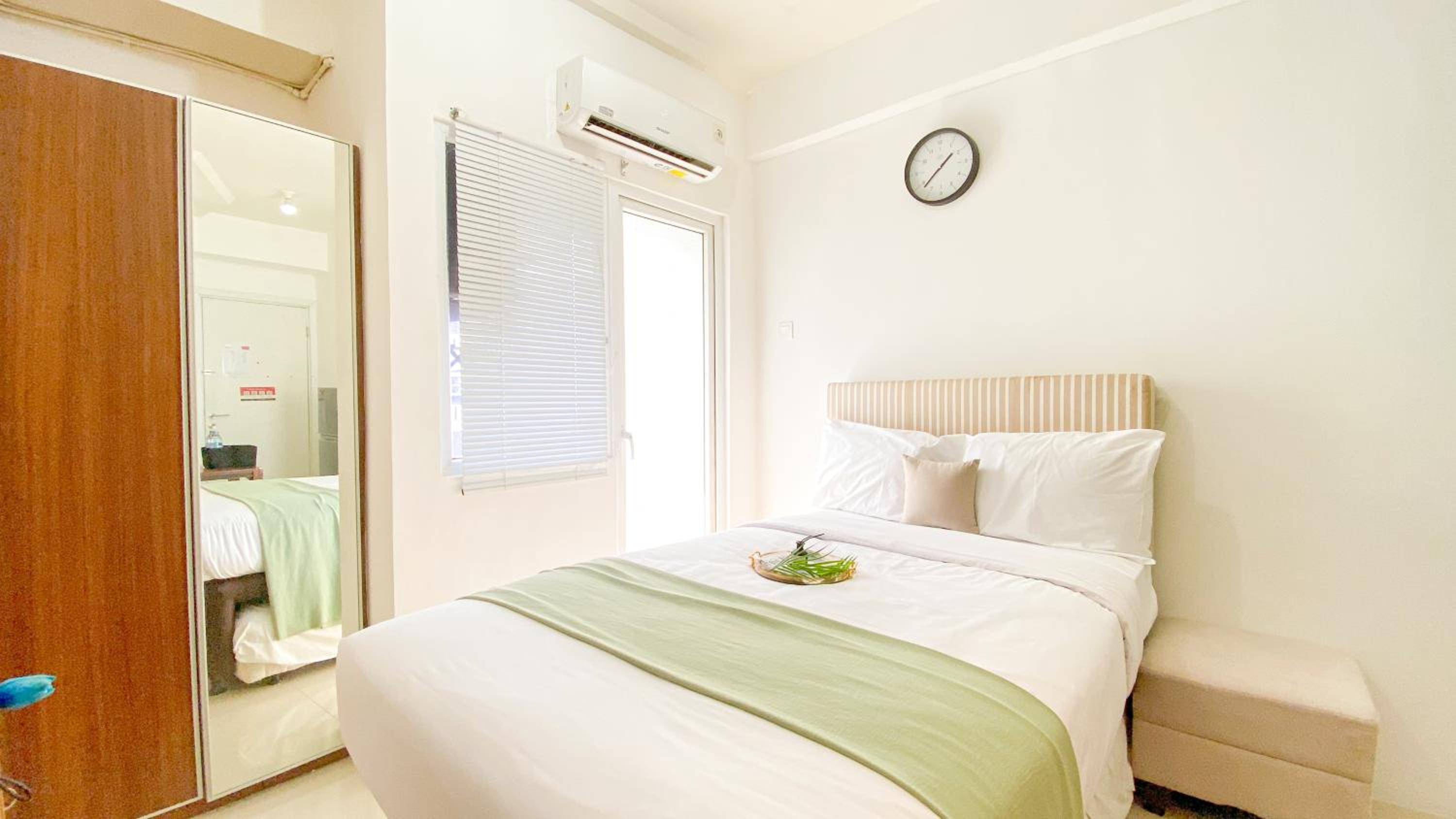 Studio Green Pramuka City Apartment with Mall Access By Travelio