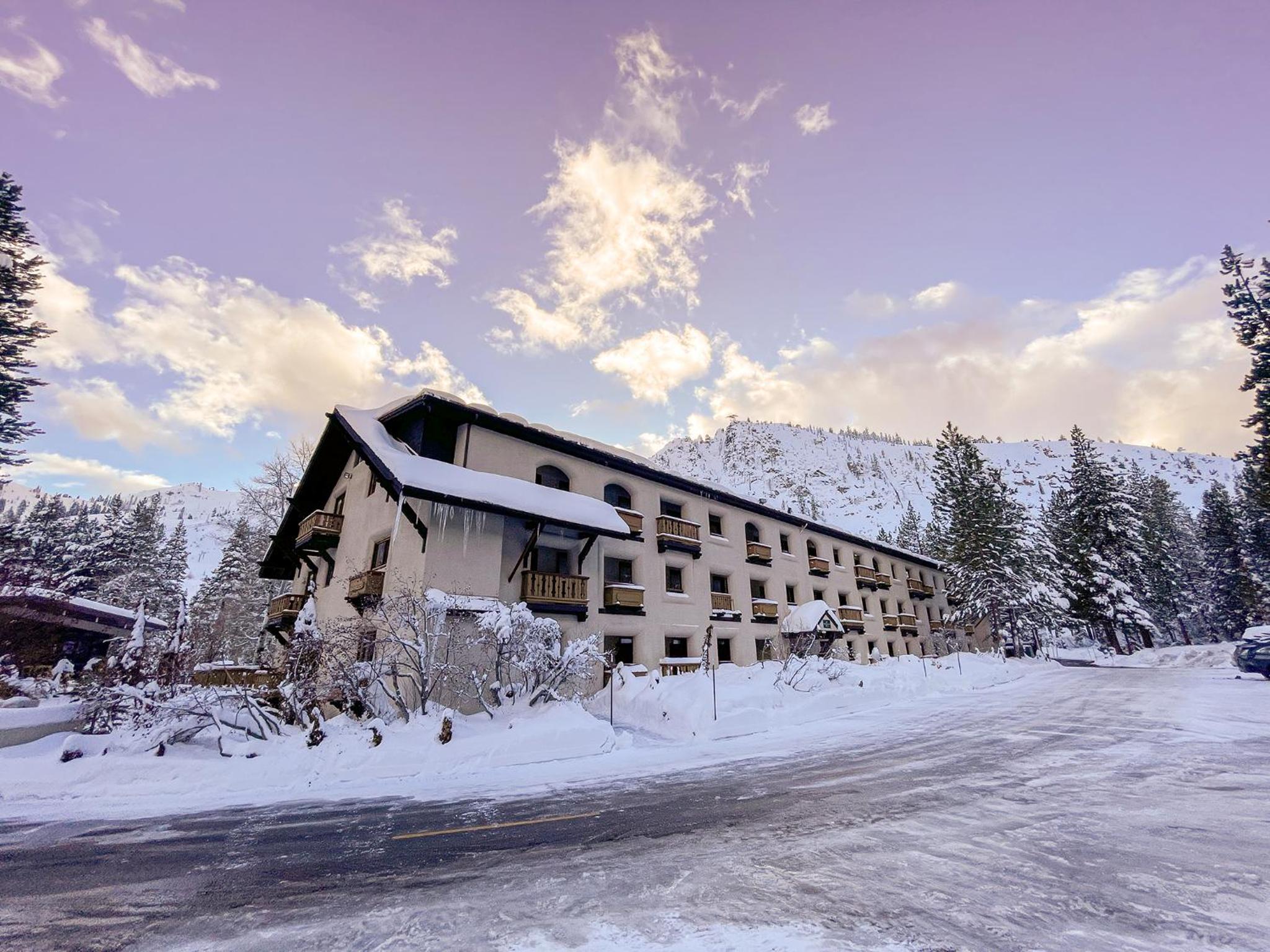 Exterior of Heavenly Village condos showing the heated pool, and back side of the building
