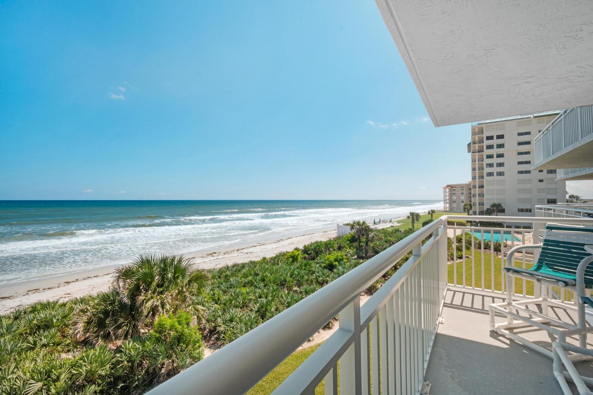 Large balcony with direct oceanfront views and access to complex pool