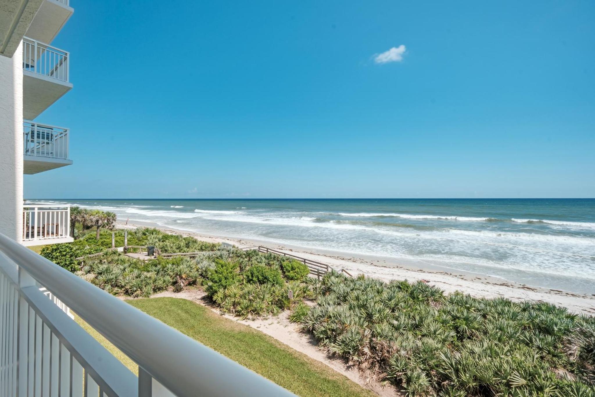 Large balcony with direct oceanfront views and access to complex pool