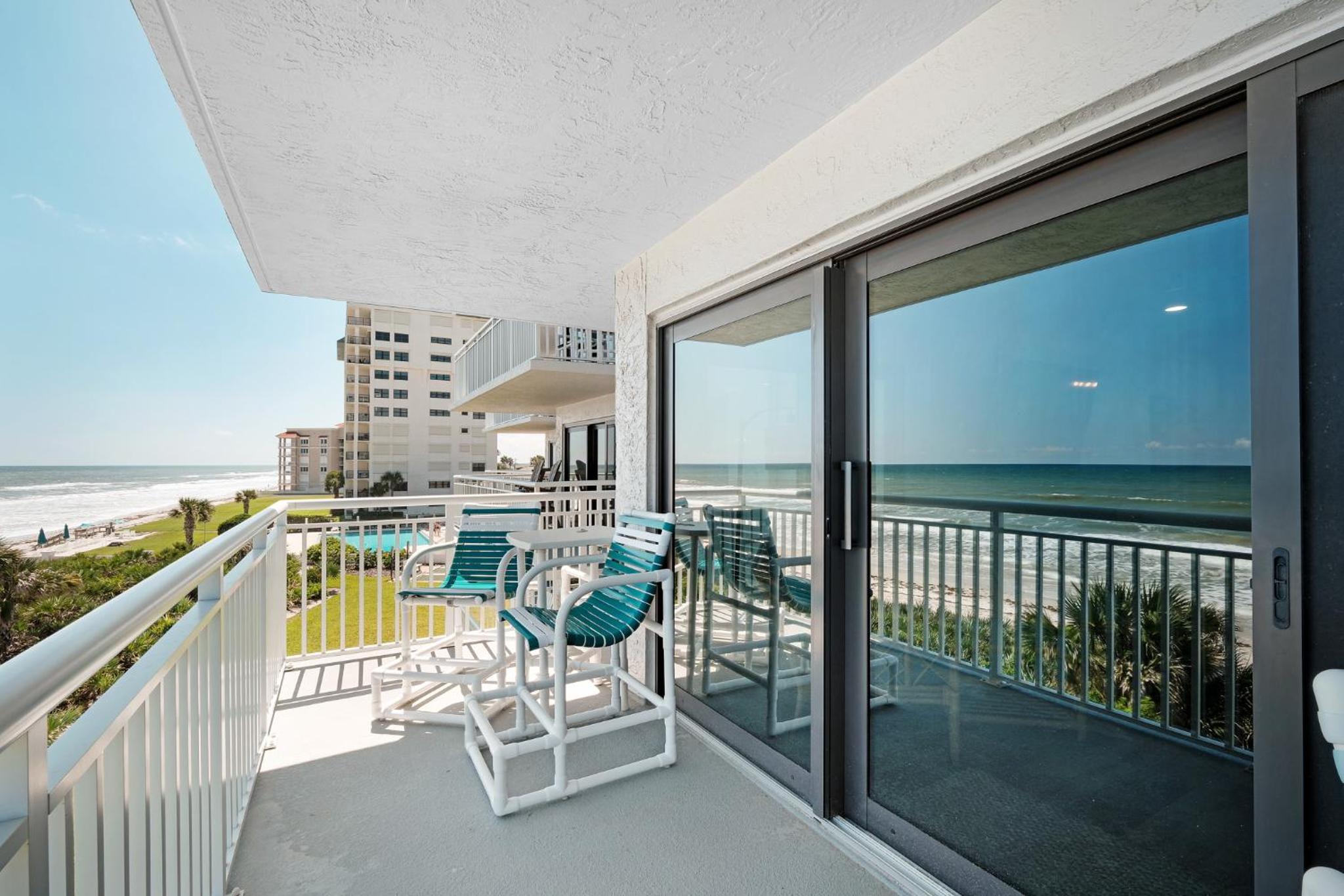Large balcony with direct oceanfront views and access to complex pool