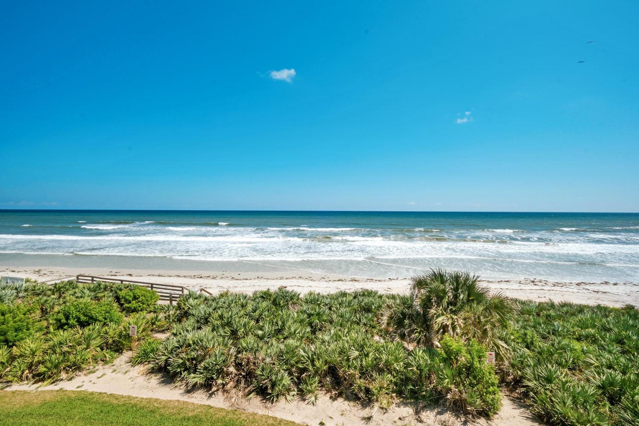 Large balcony with direct oceanfront views and access to complex pool