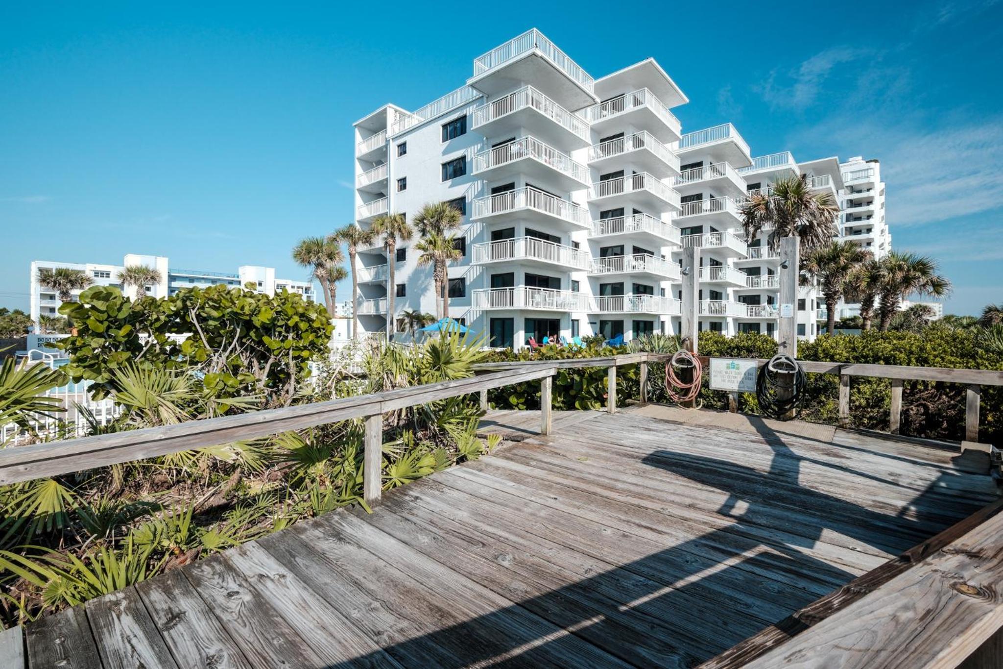 Large balcony with direct oceanfront views and access to complex pool