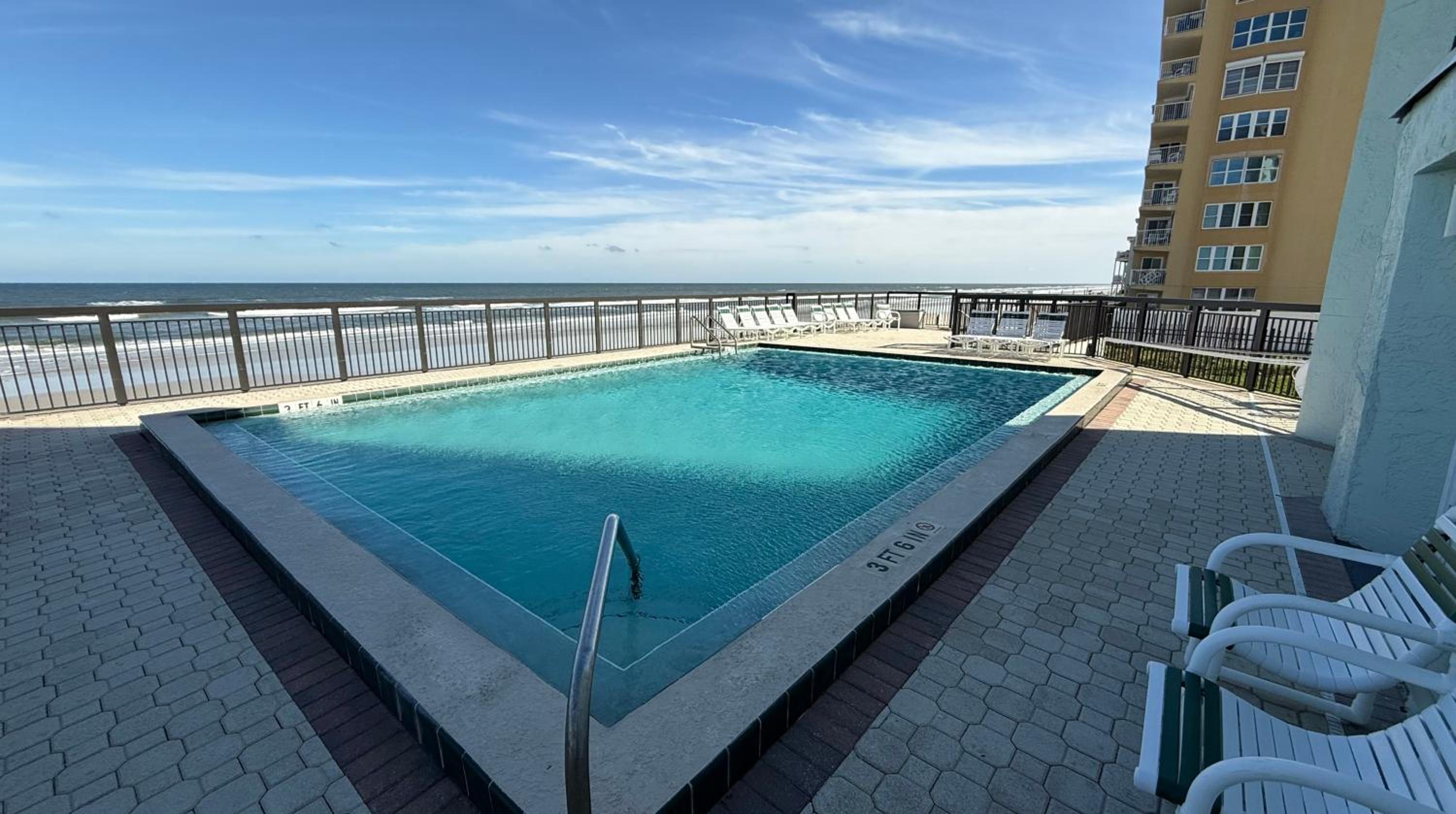Top-floor ocean view condo with a private balcony and beachfront pool