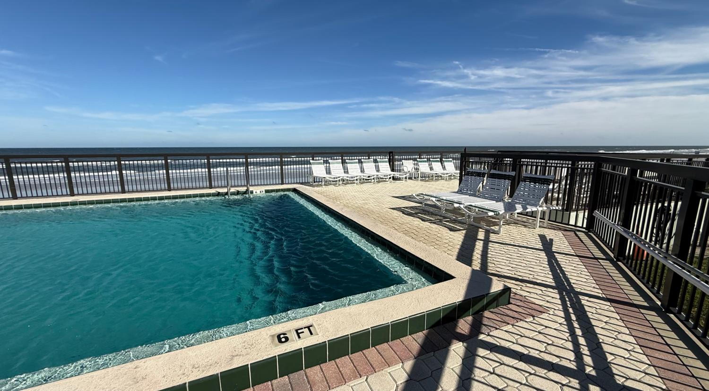 Top-floor ocean view condo with a private balcony and beachfront pool
