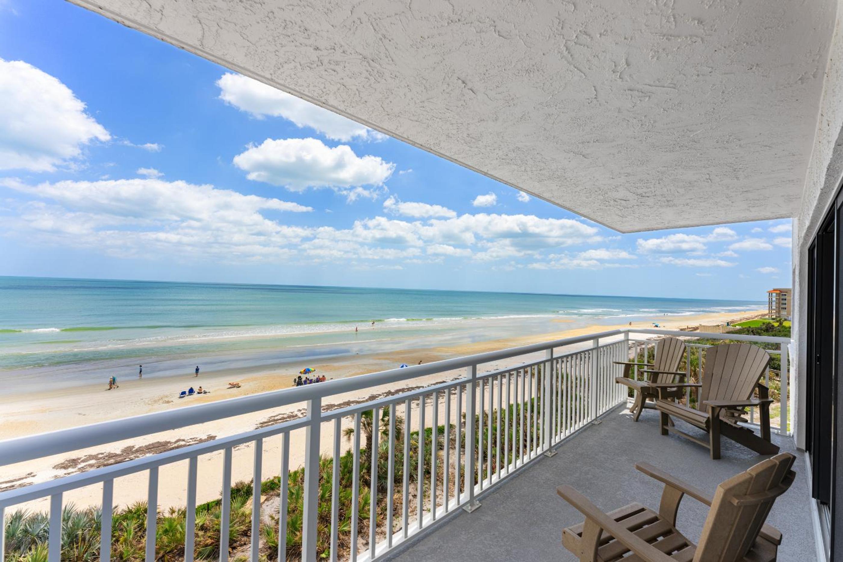 Updated direct oceanfront corner with a wrap-around balcony, heated pool and beach access