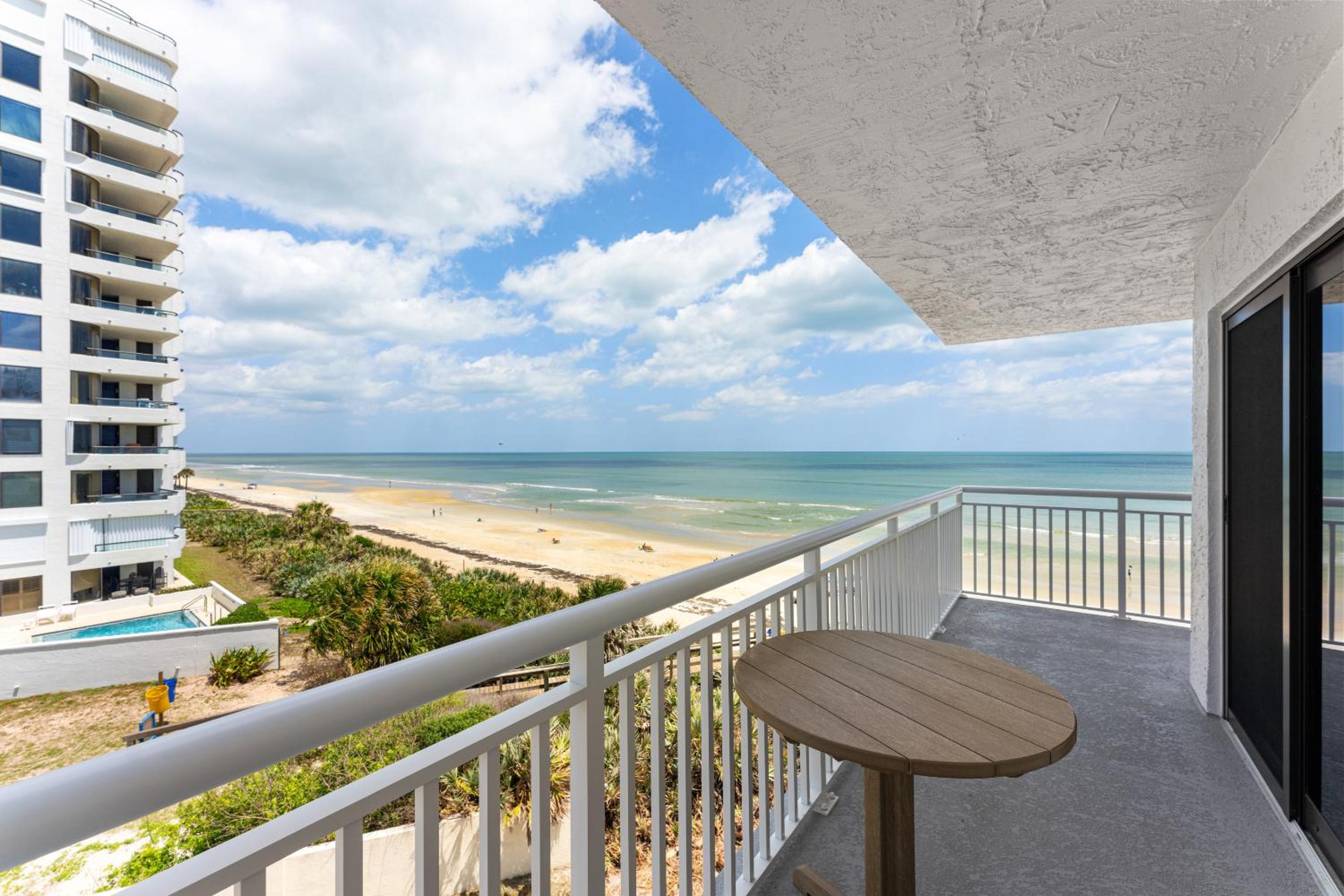 Updated direct oceanfront corner with a wrap-around balcony, heated pool and beach access