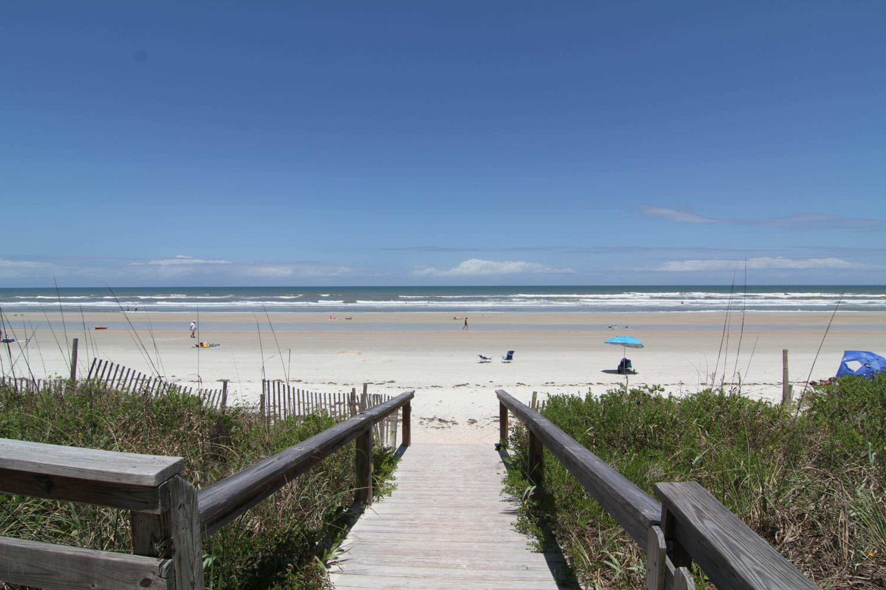Updated direct oceanfront corner with a wrap-around balcony, heated pool and beach access