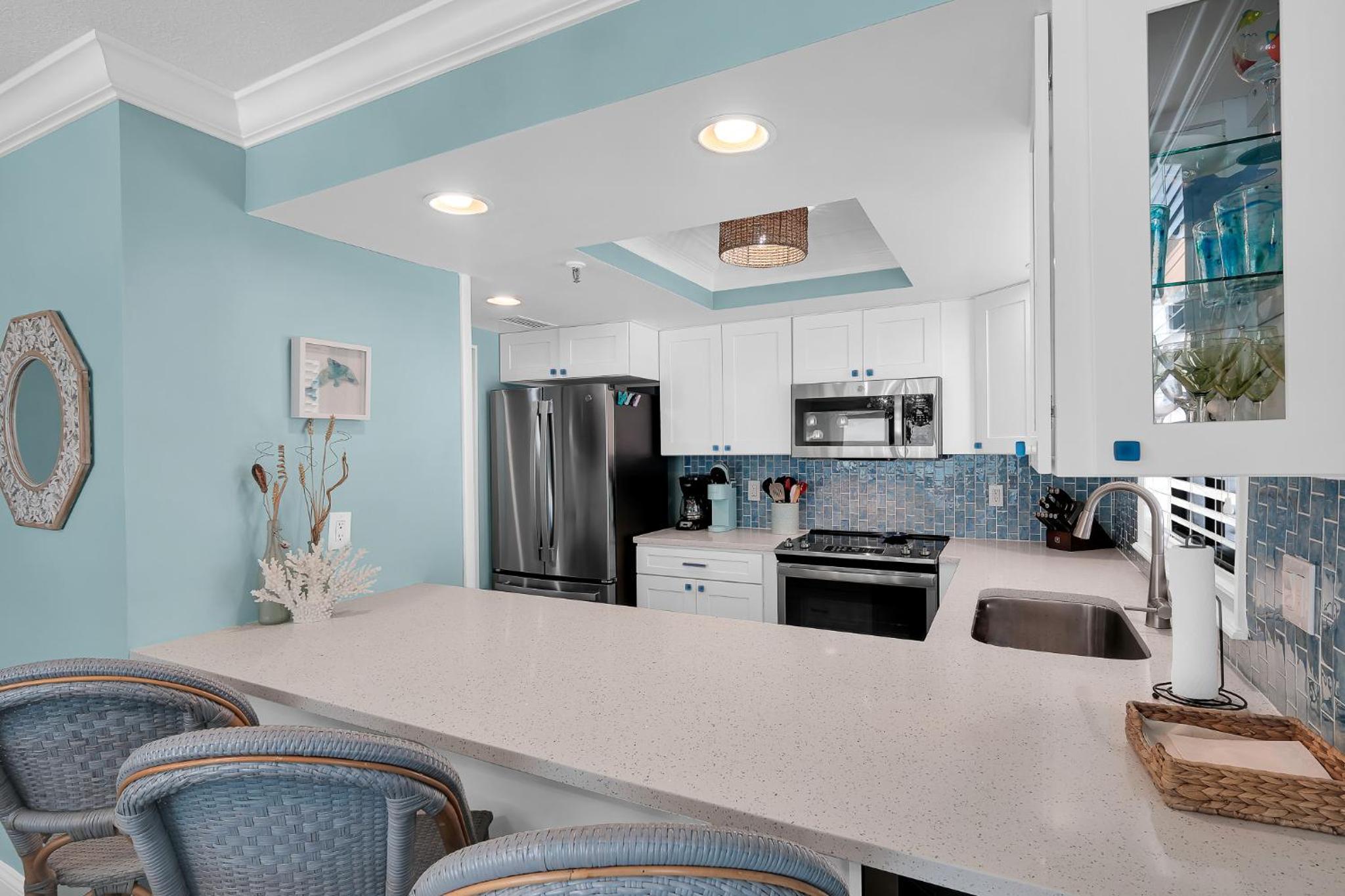 Updated direct oceanfront corner with a wrap-around balcony, heated pool and beach access