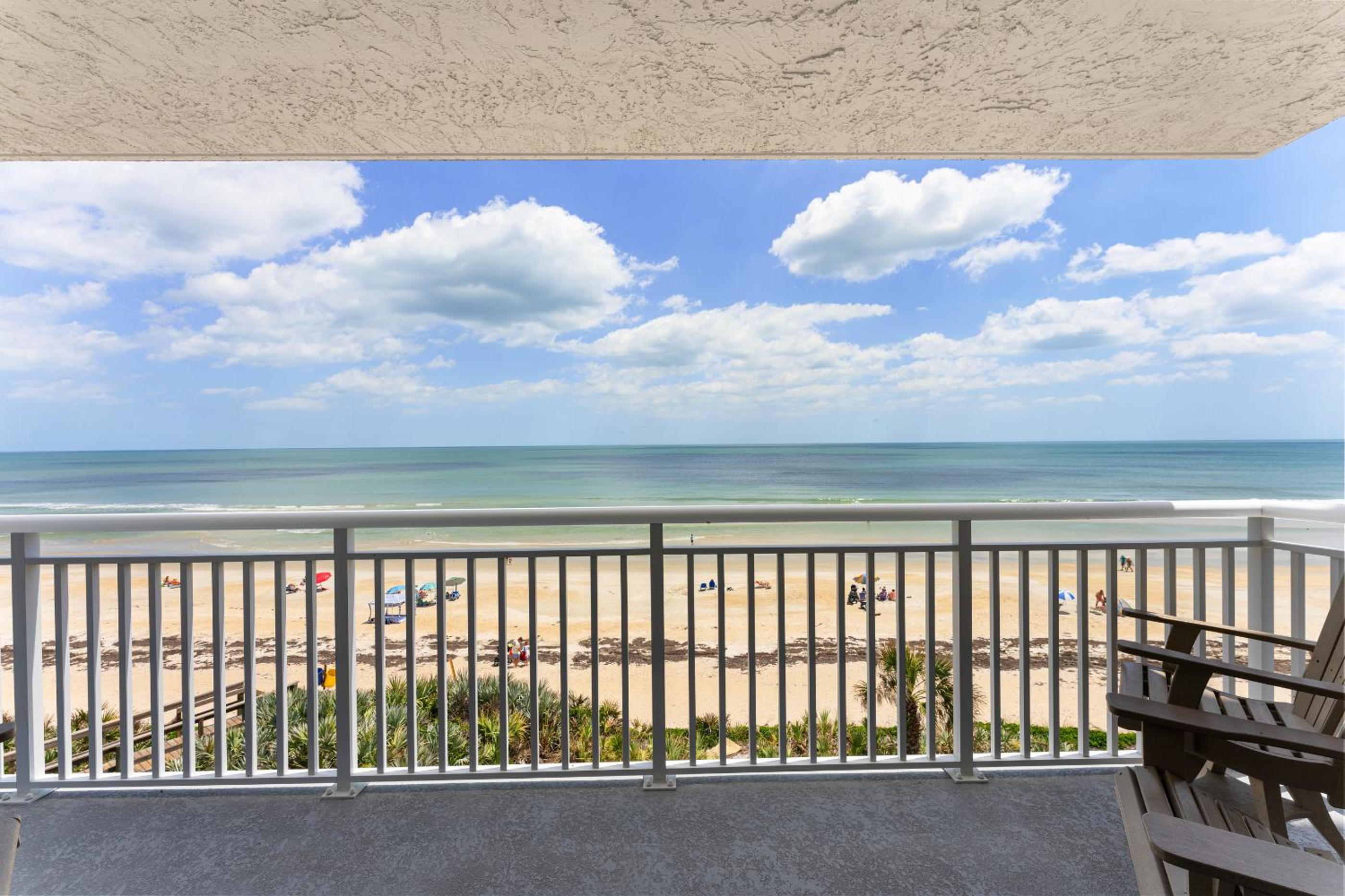 Updated direct oceanfront corner with a wrap-around balcony, heated pool and beach access