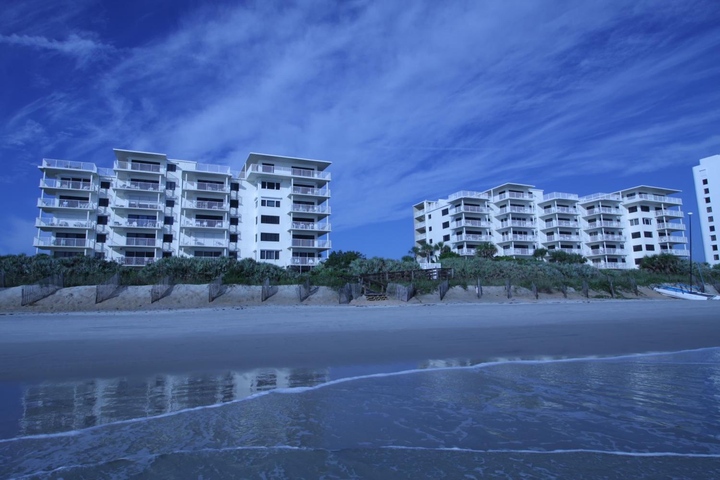 Updated direct oceanfront corner with a wrap-around balcony, heated pool and beach access