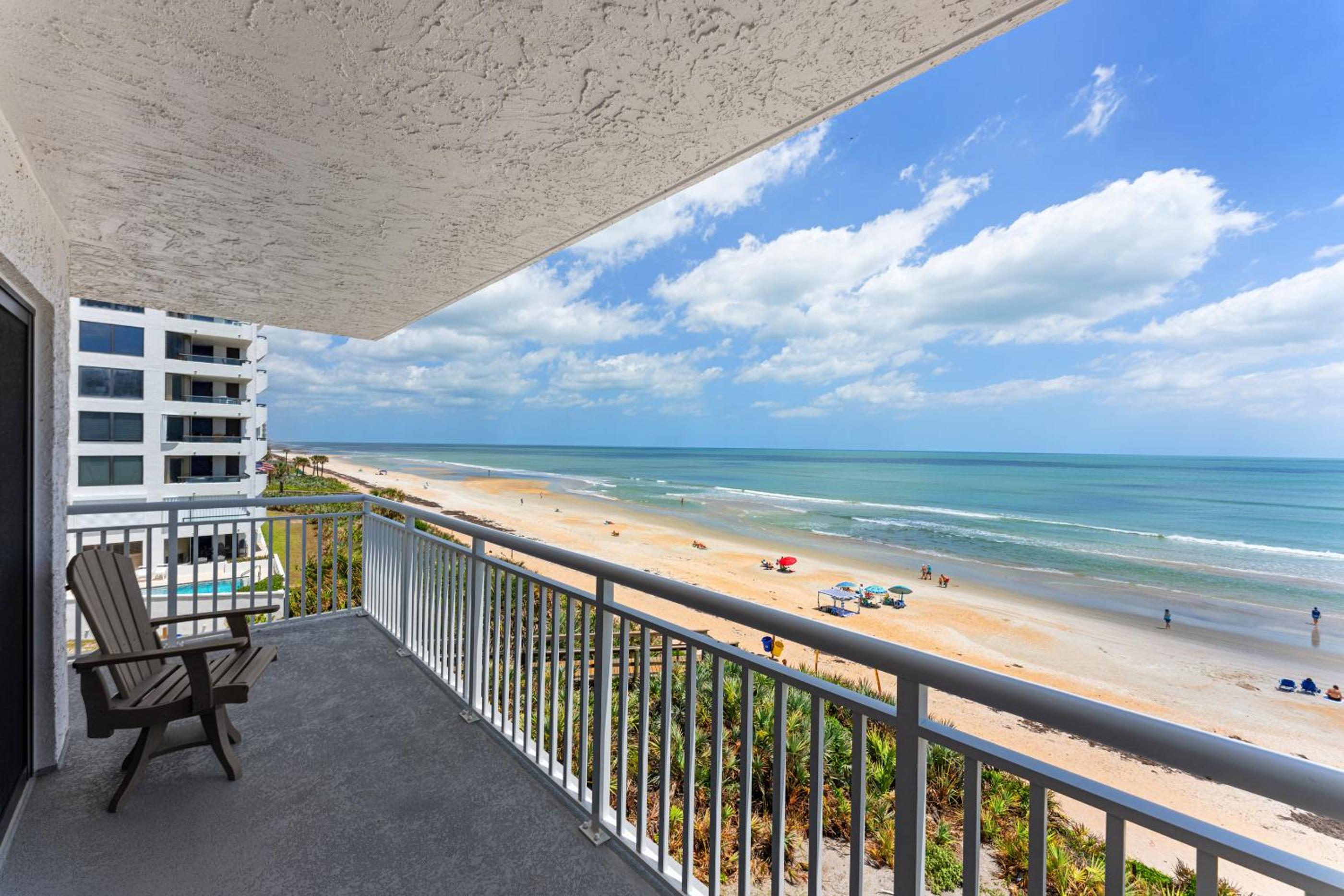 Updated direct oceanfront corner with a wrap-around balcony, heated pool and beach access