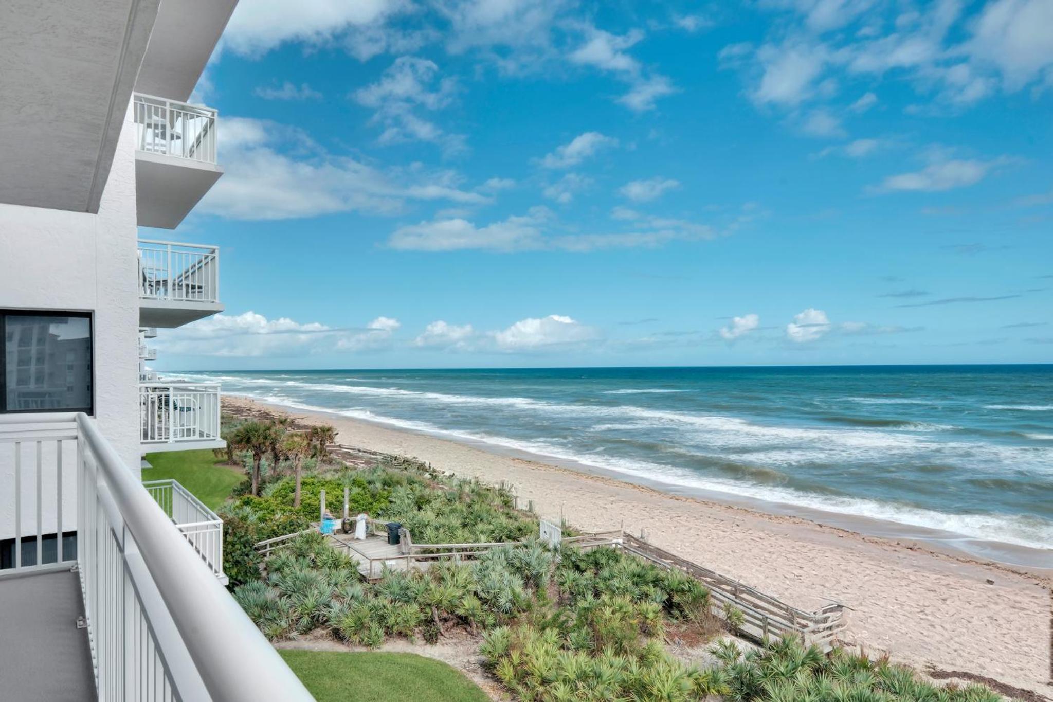 Direct oceanfront condo with a large balcony and a heated beachfront pool