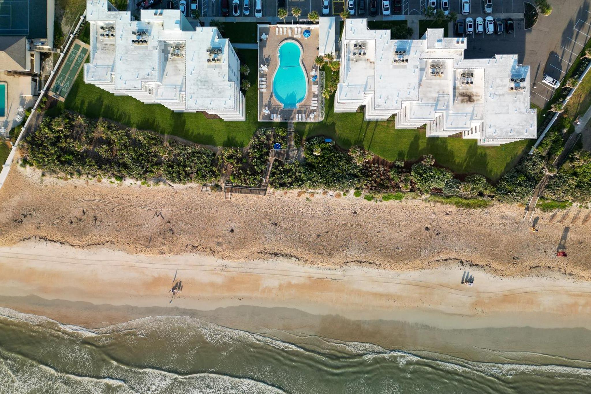 Direct oceanfront condo with a large balcony and a heated beachfront pool