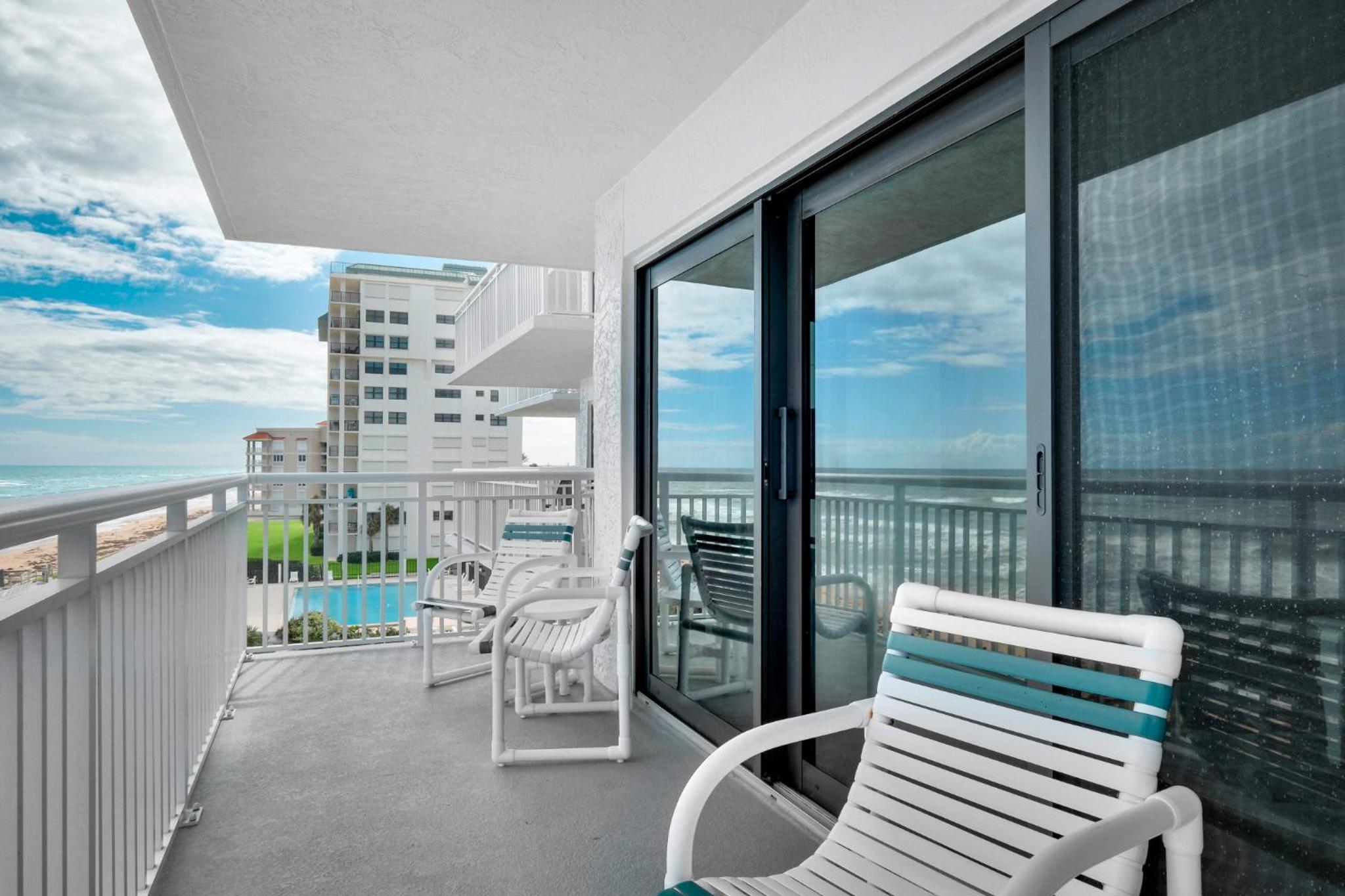 Direct oceanfront condo with a large balcony and a heated beachfront pool