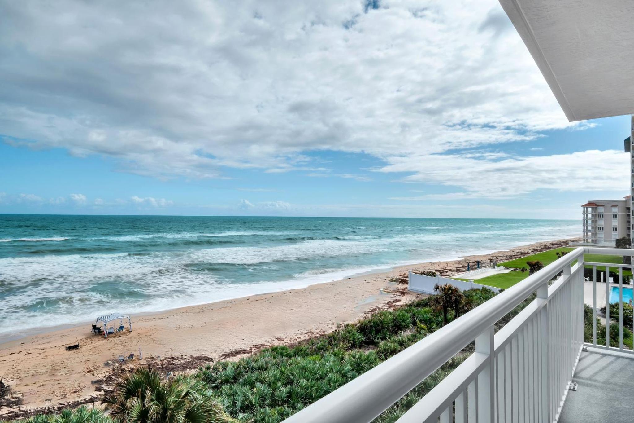 Direct oceanfront condo with a large balcony and a heated beachfront pool