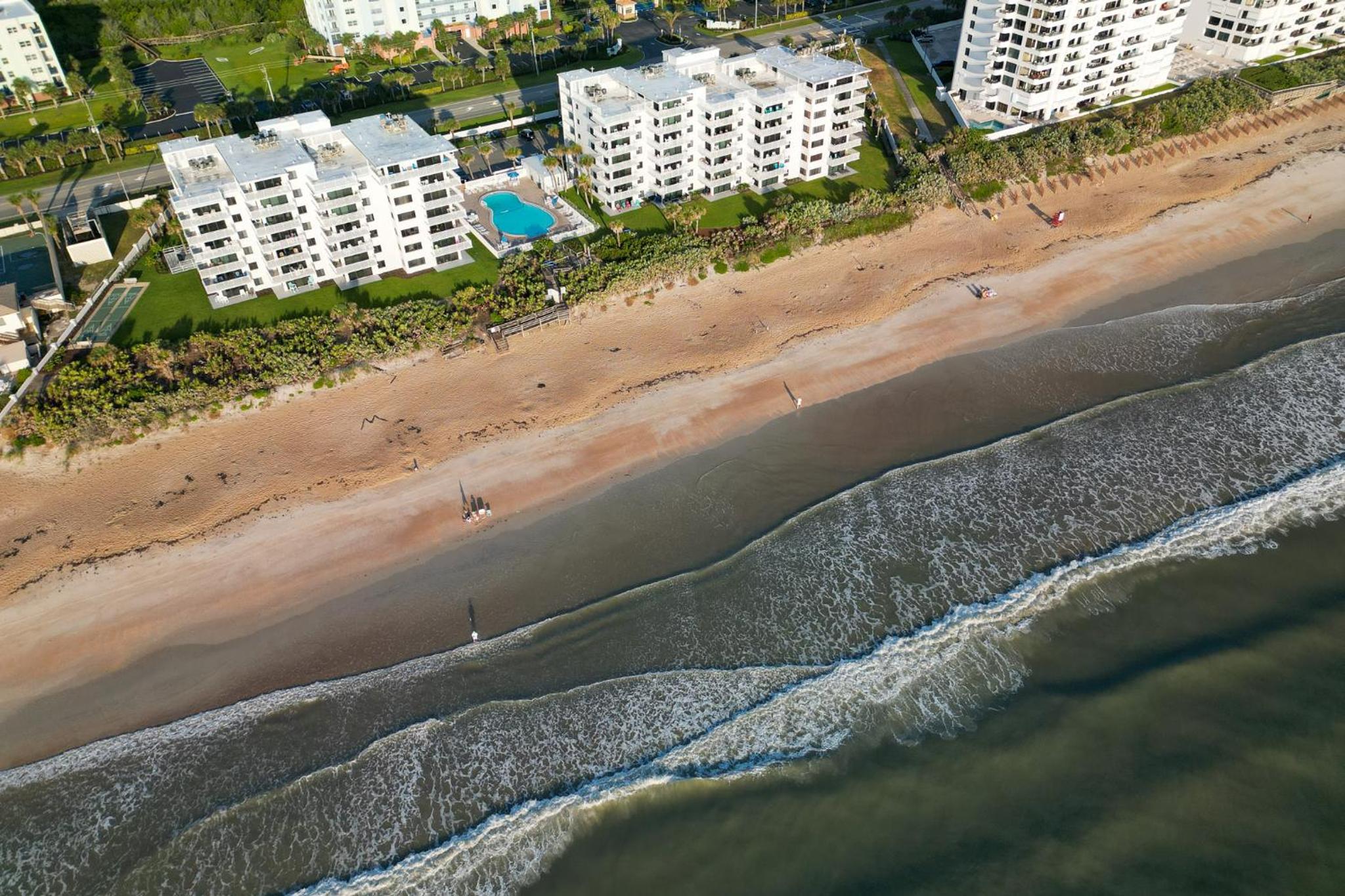 Direct oceanfront condo with a large balcony and a heated beachfront pool