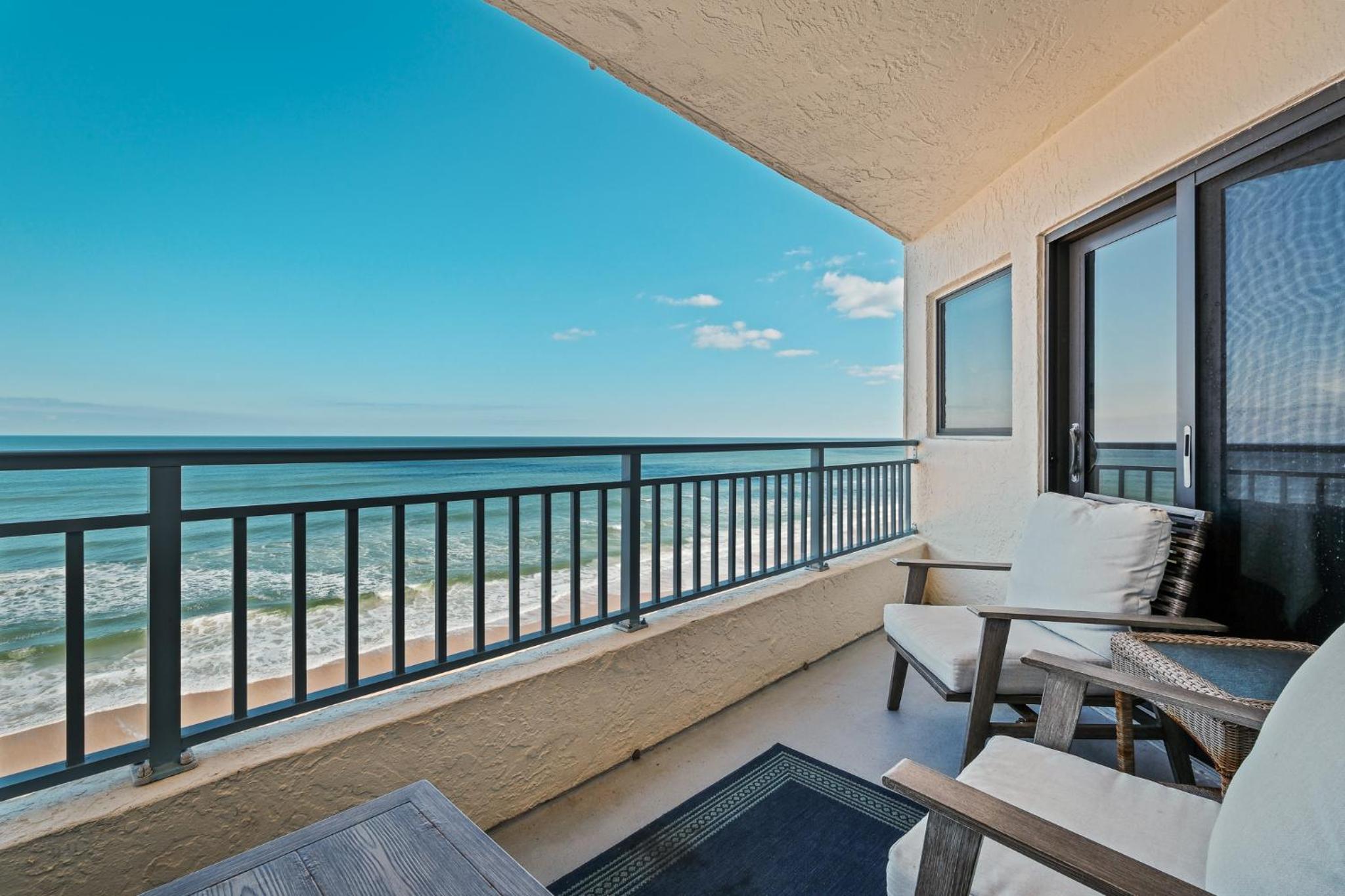 Stunning direct oceanfront condo with a balcony, hot tub, and heated pool