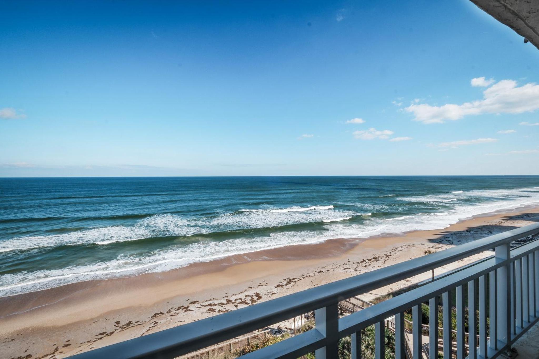 Stunning direct oceanfront condo with a balcony, hot tub, and heated pool
