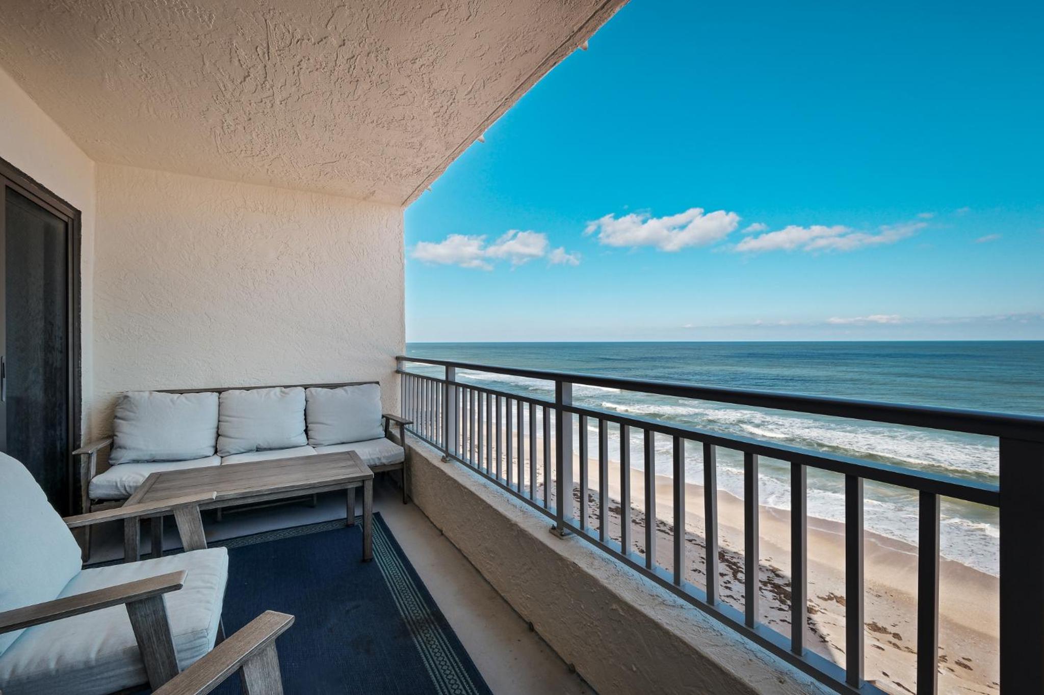 Stunning direct oceanfront condo with a balcony, hot tub, and heated pool
