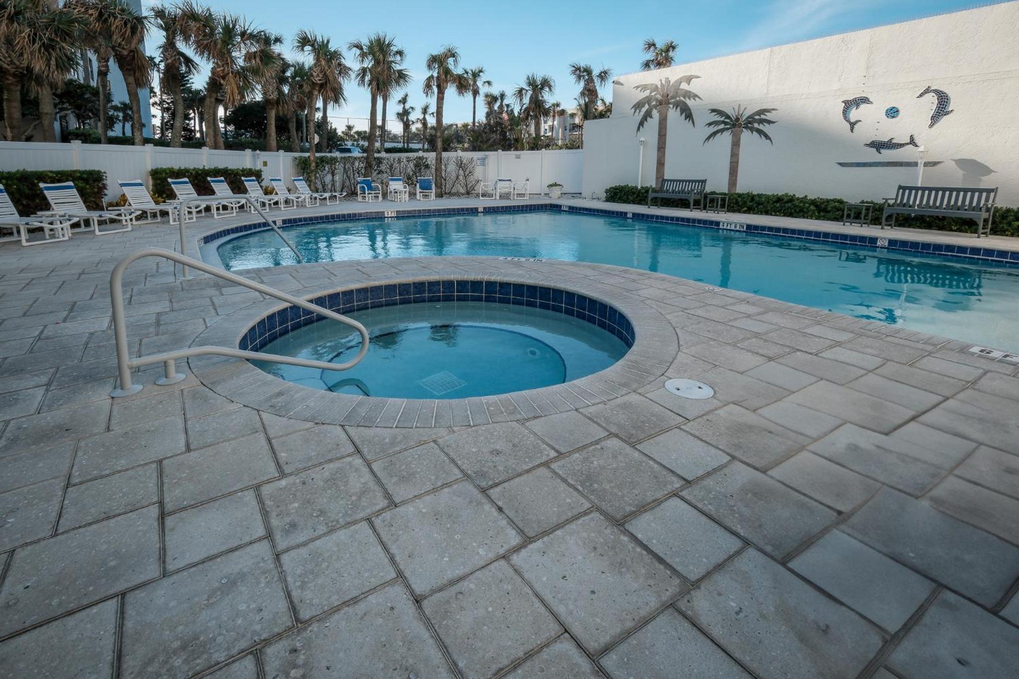 Stunning direct oceanfront condo with a balcony, hot tub, and heated pool