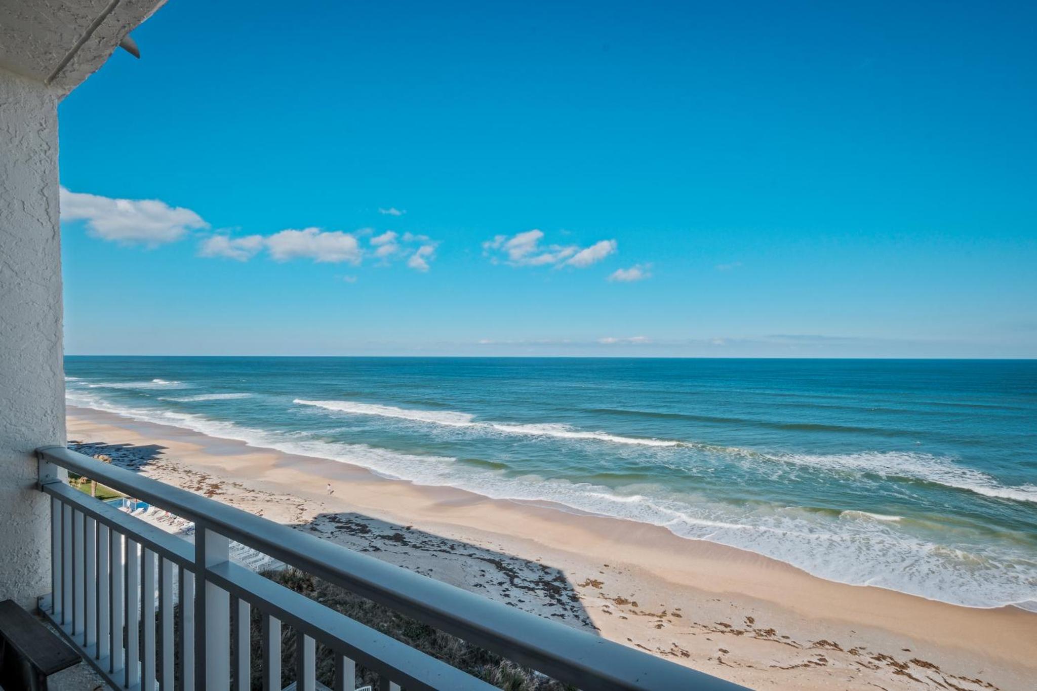 Stunning direct oceanfront condo with a balcony, hot tub, and heated pool
