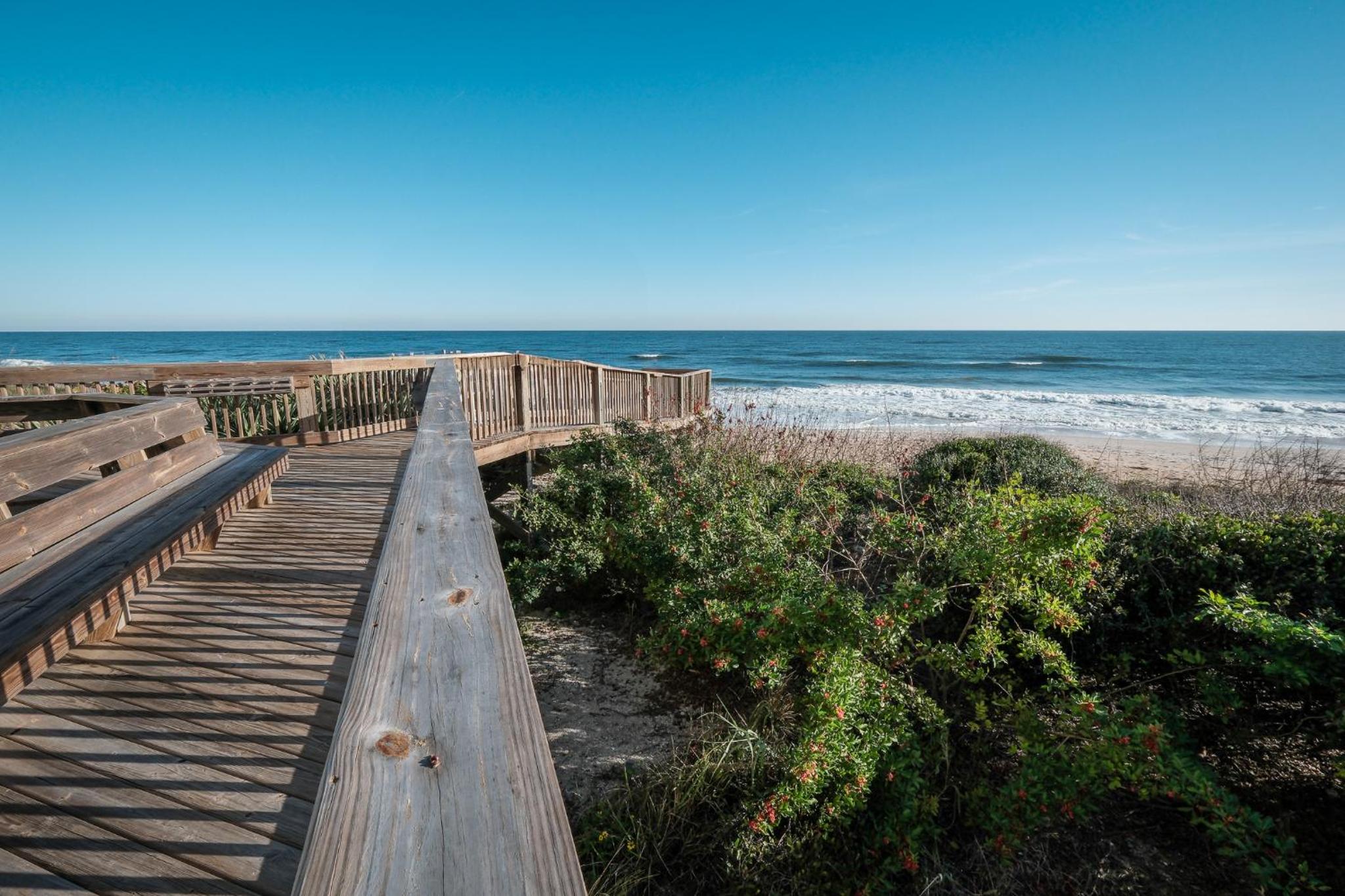 Stunning direct oceanfront condo with a balcony, hot tub, and heated pool