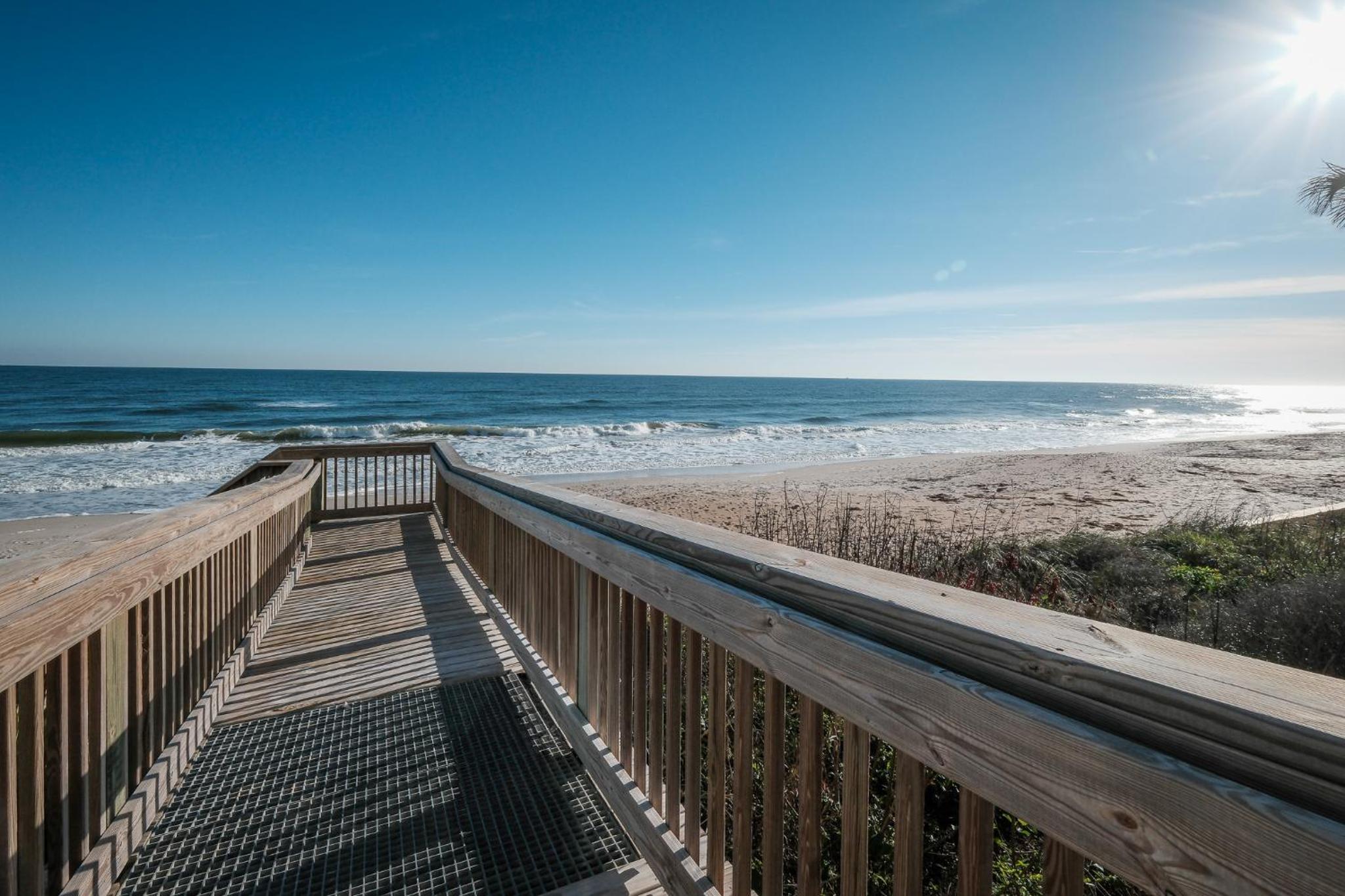 Stunning direct oceanfront condo with a balcony, hot tub, and heated pool