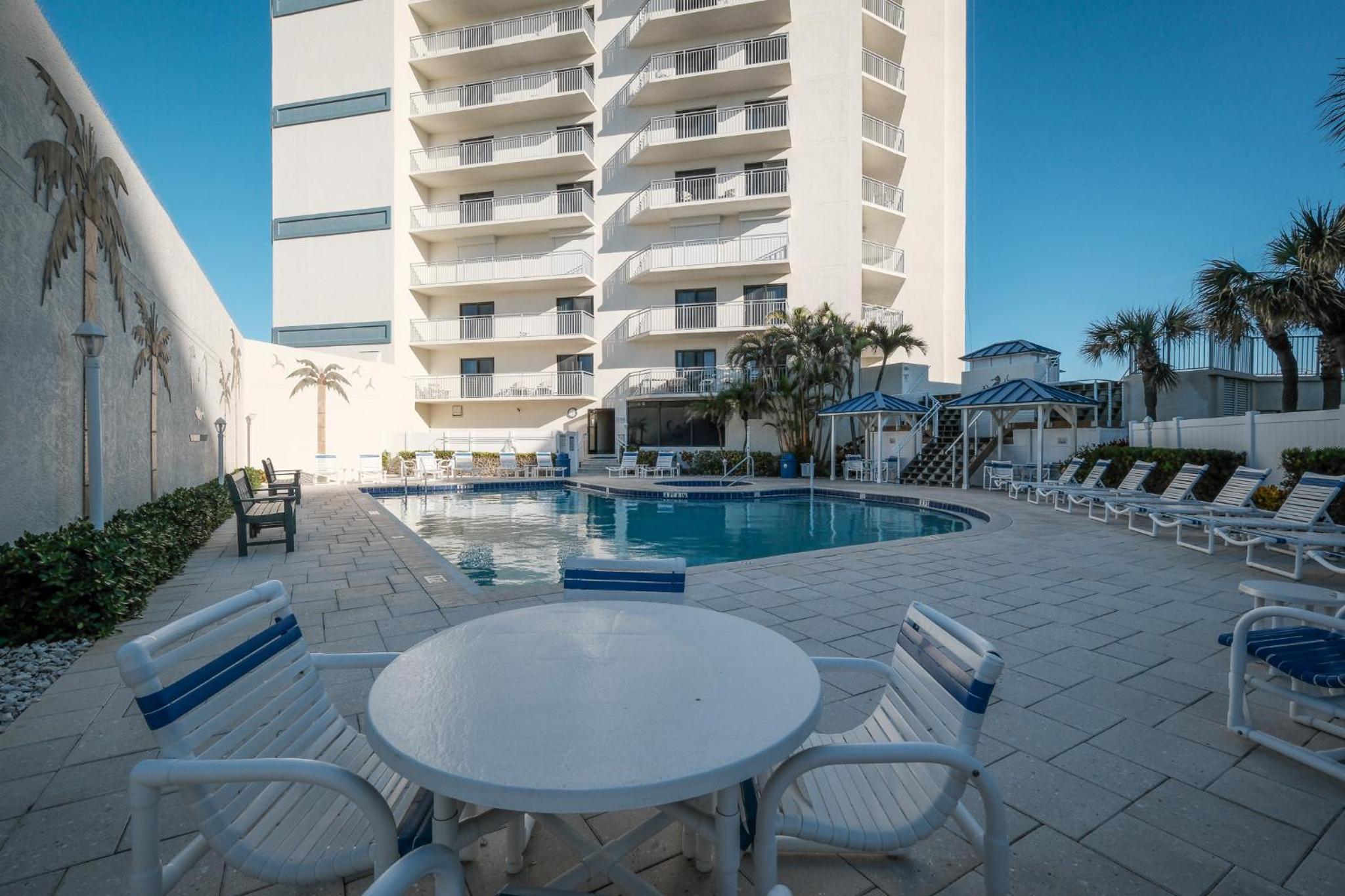 Stunning direct oceanfront condo with a balcony, hot tub, and heated pool