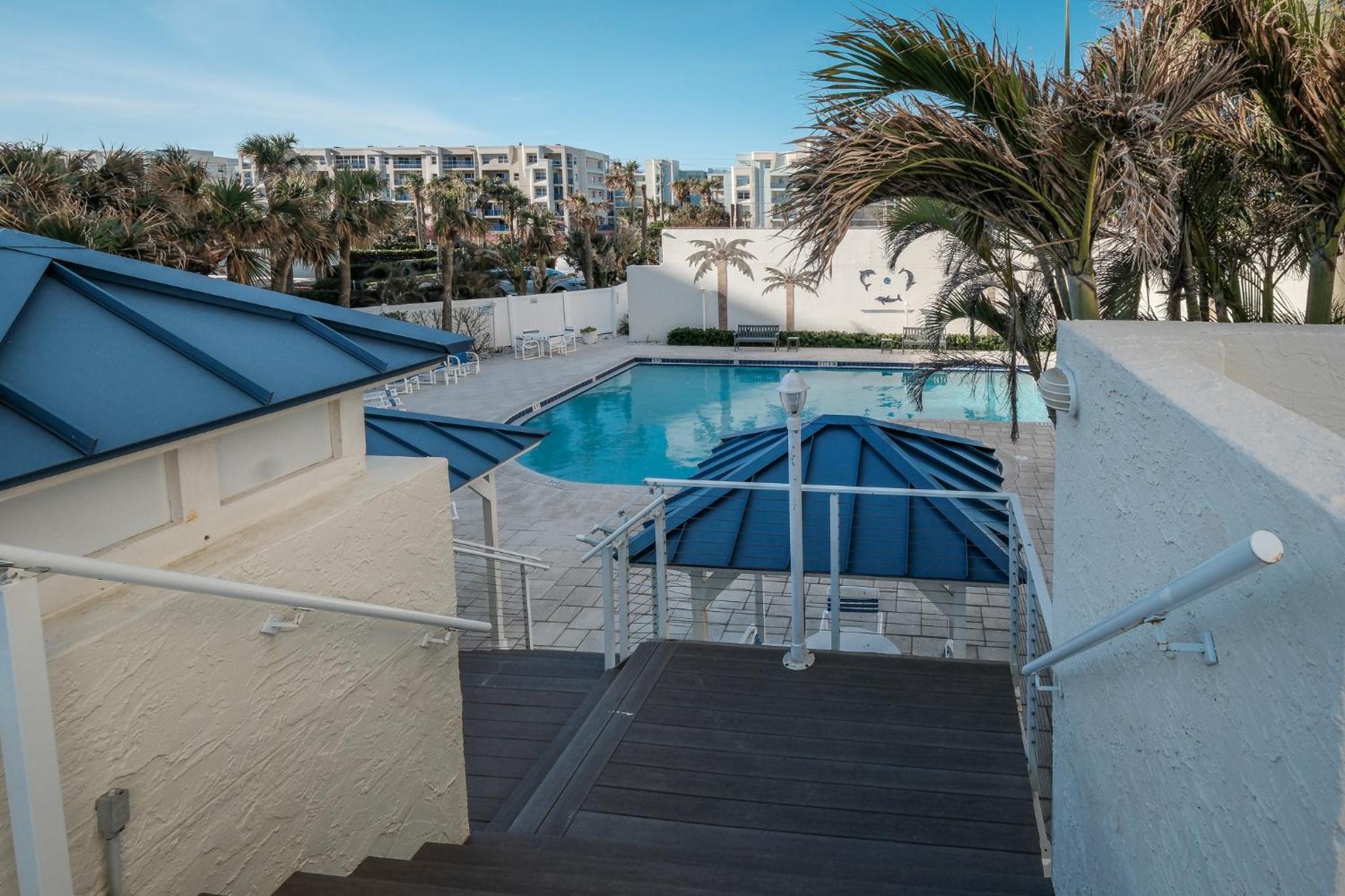 Stunning direct oceanfront condo with a balcony, hot tub, and heated pool